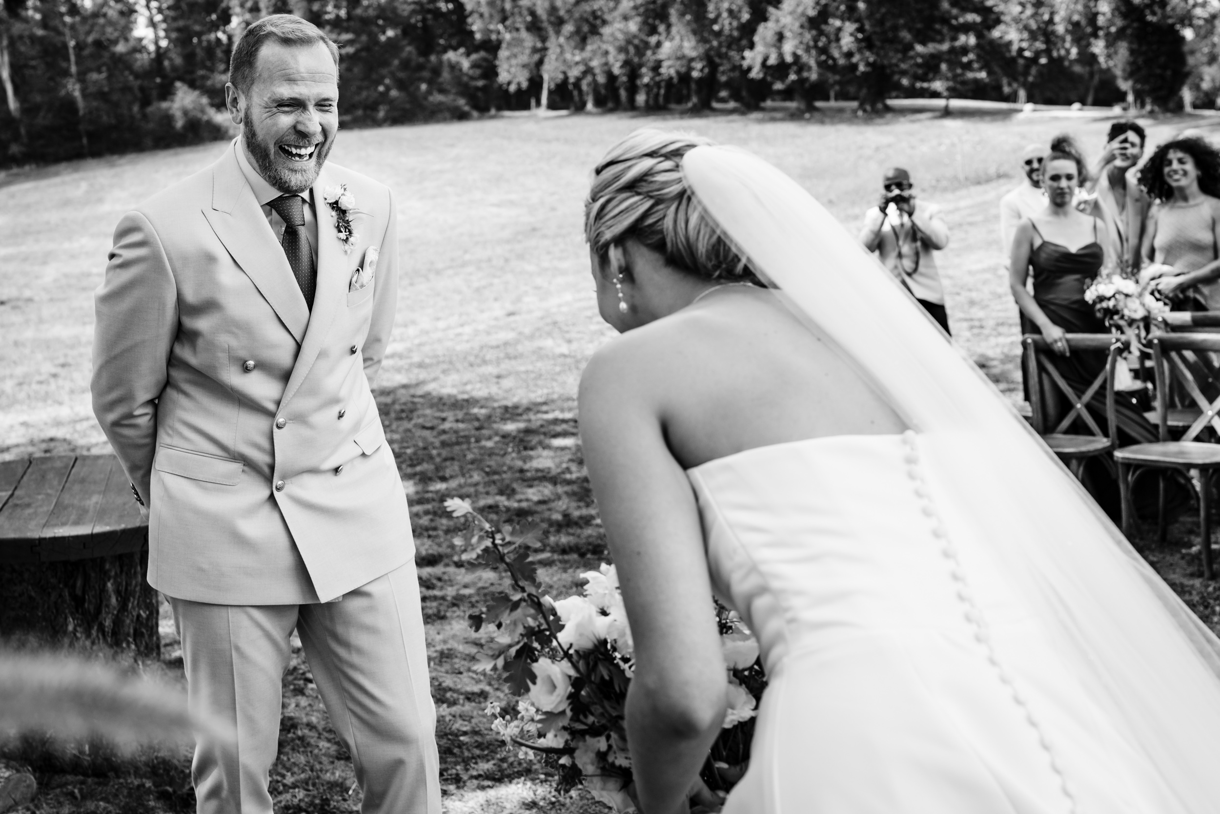 Groom laughing as he reacts to seeing the bride during the ceremony