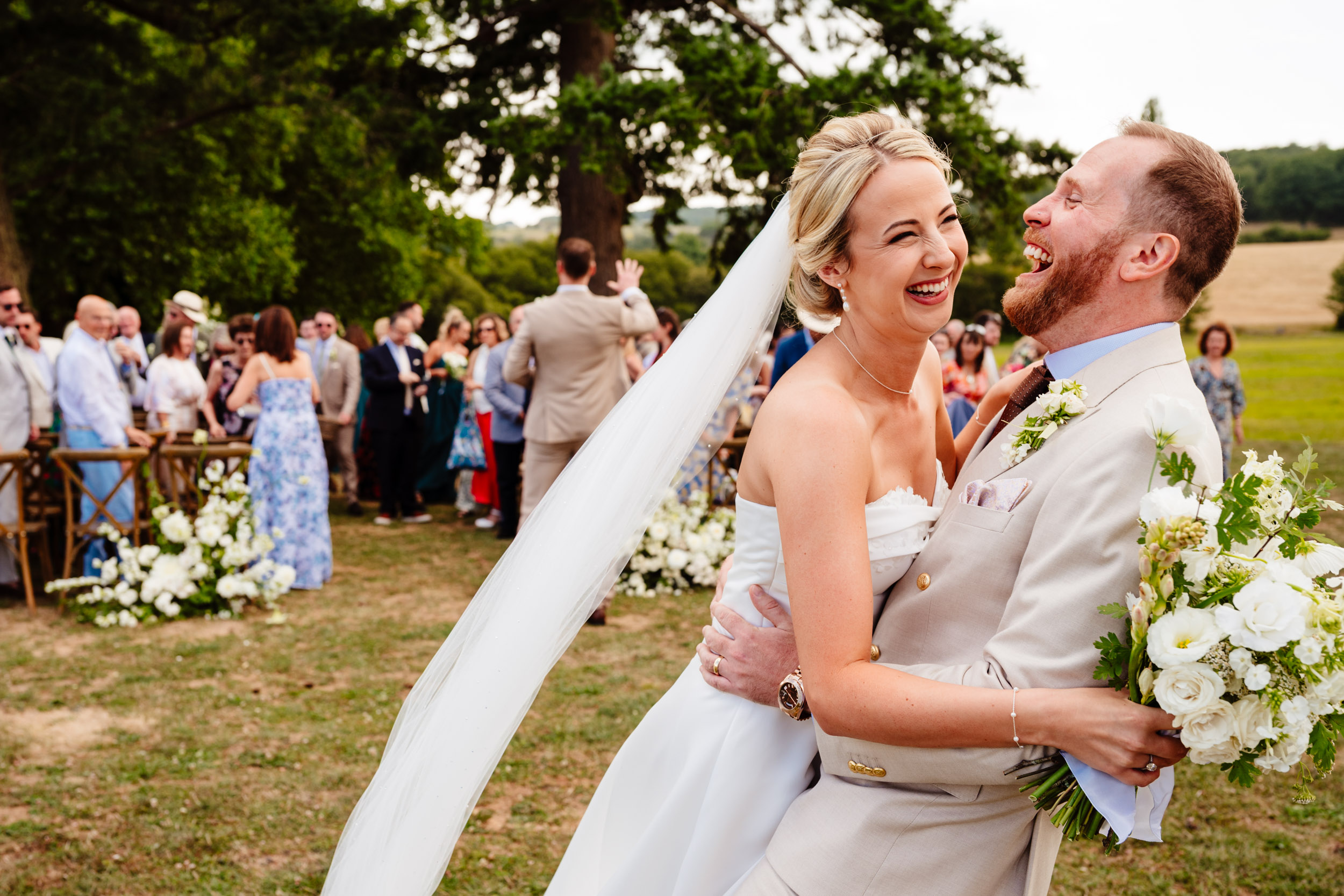 Bride and groom hugging and laughing together just after the ceremony