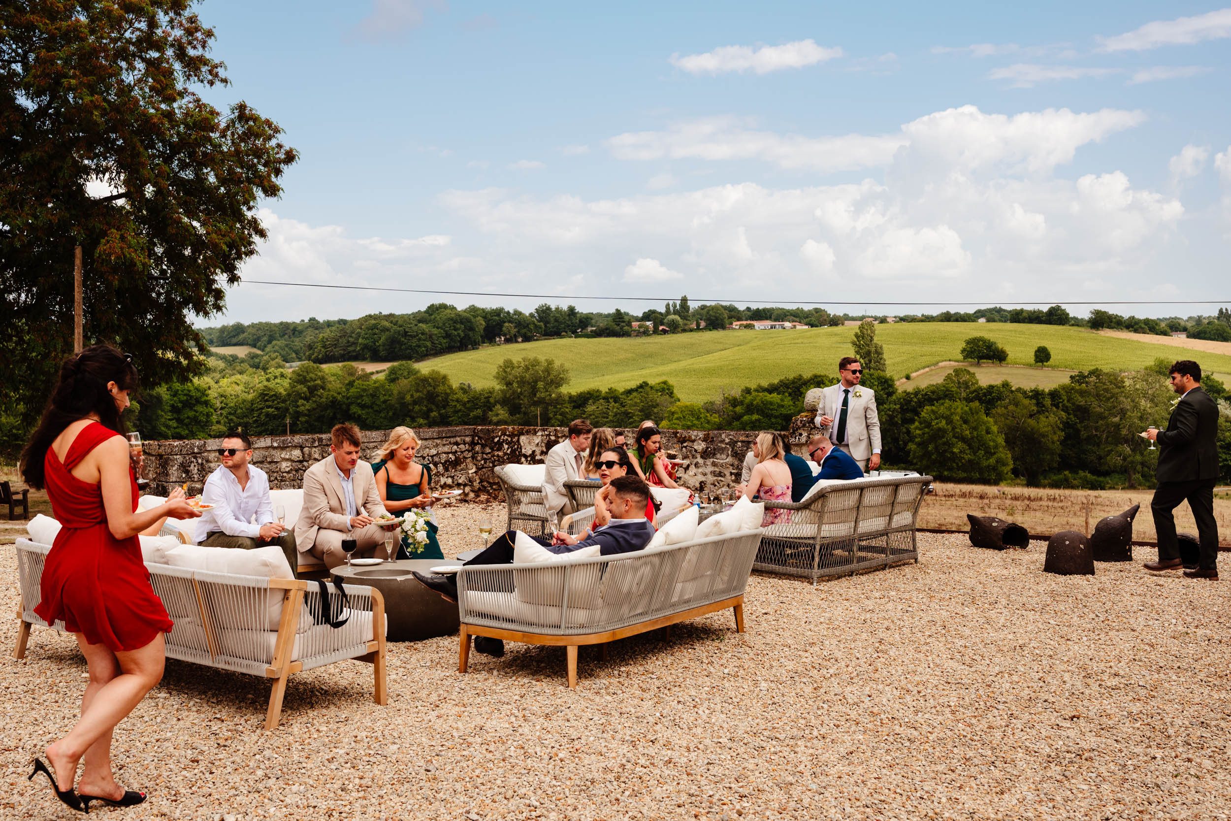 Wide view of the hills surrounding Chateau de Lerse with guests enjoying the drinks reception