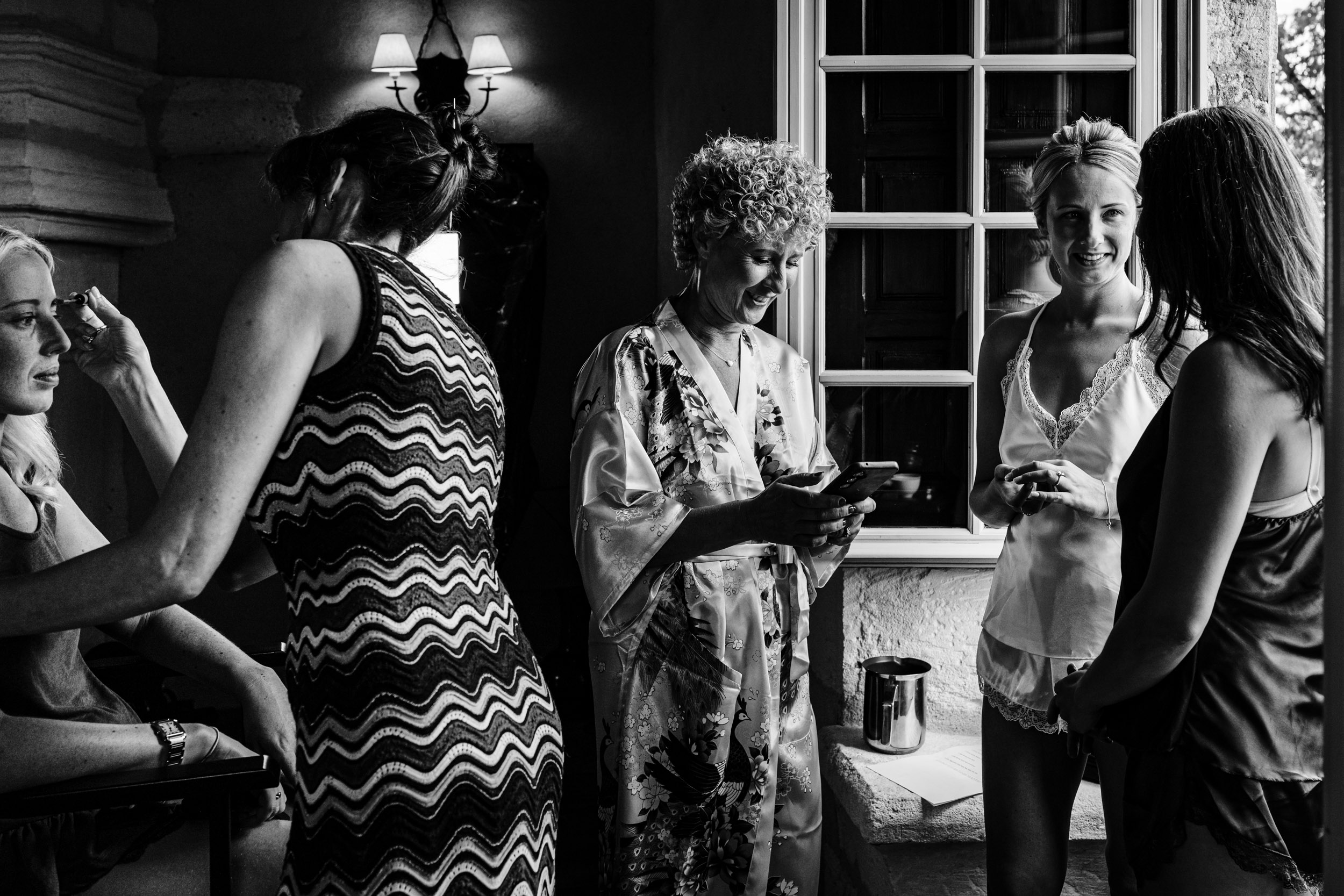 Bridal party getting ready in soft window light inside Chateau de Lerse