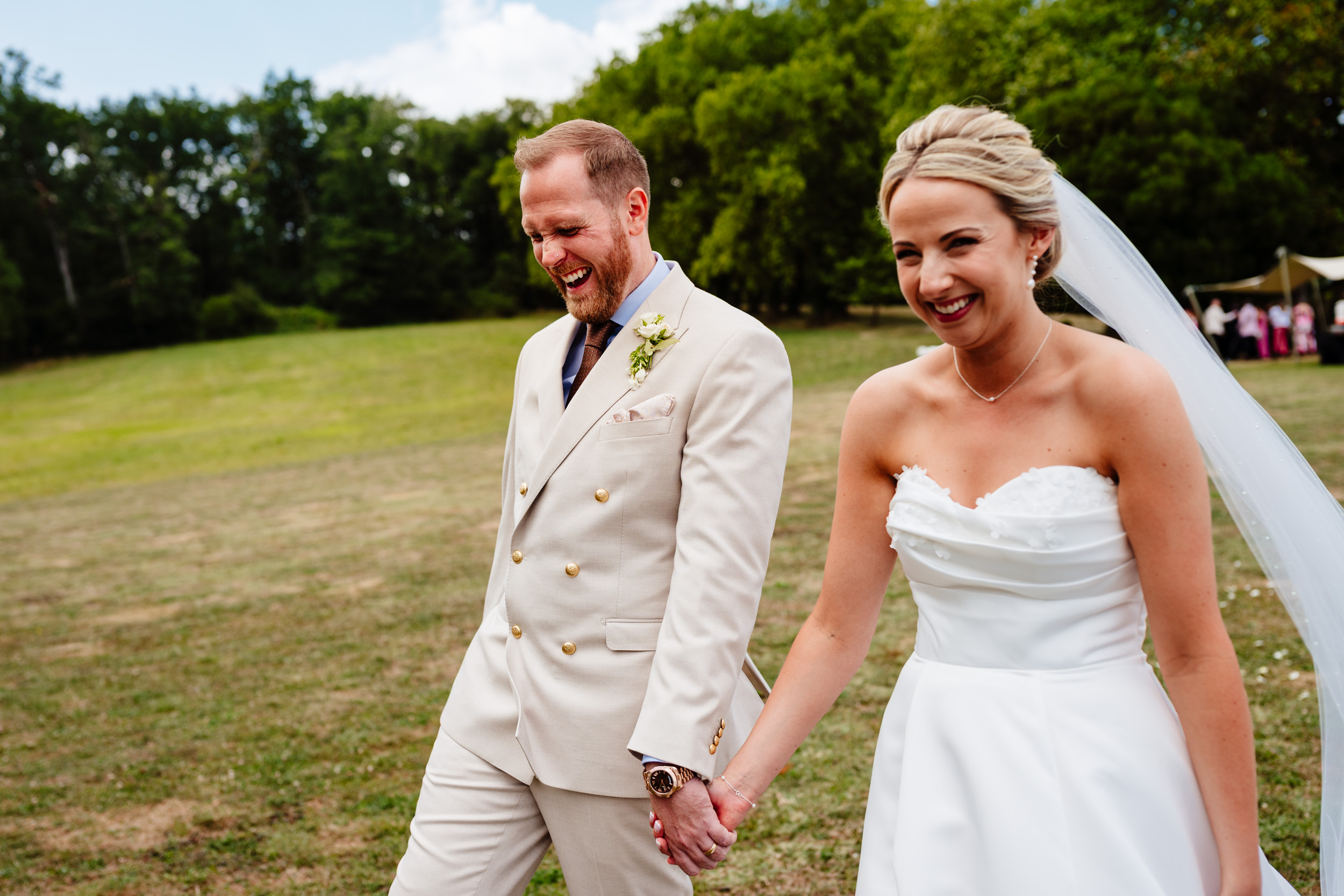 Bride and groom laughing together during relaxed couple portraits