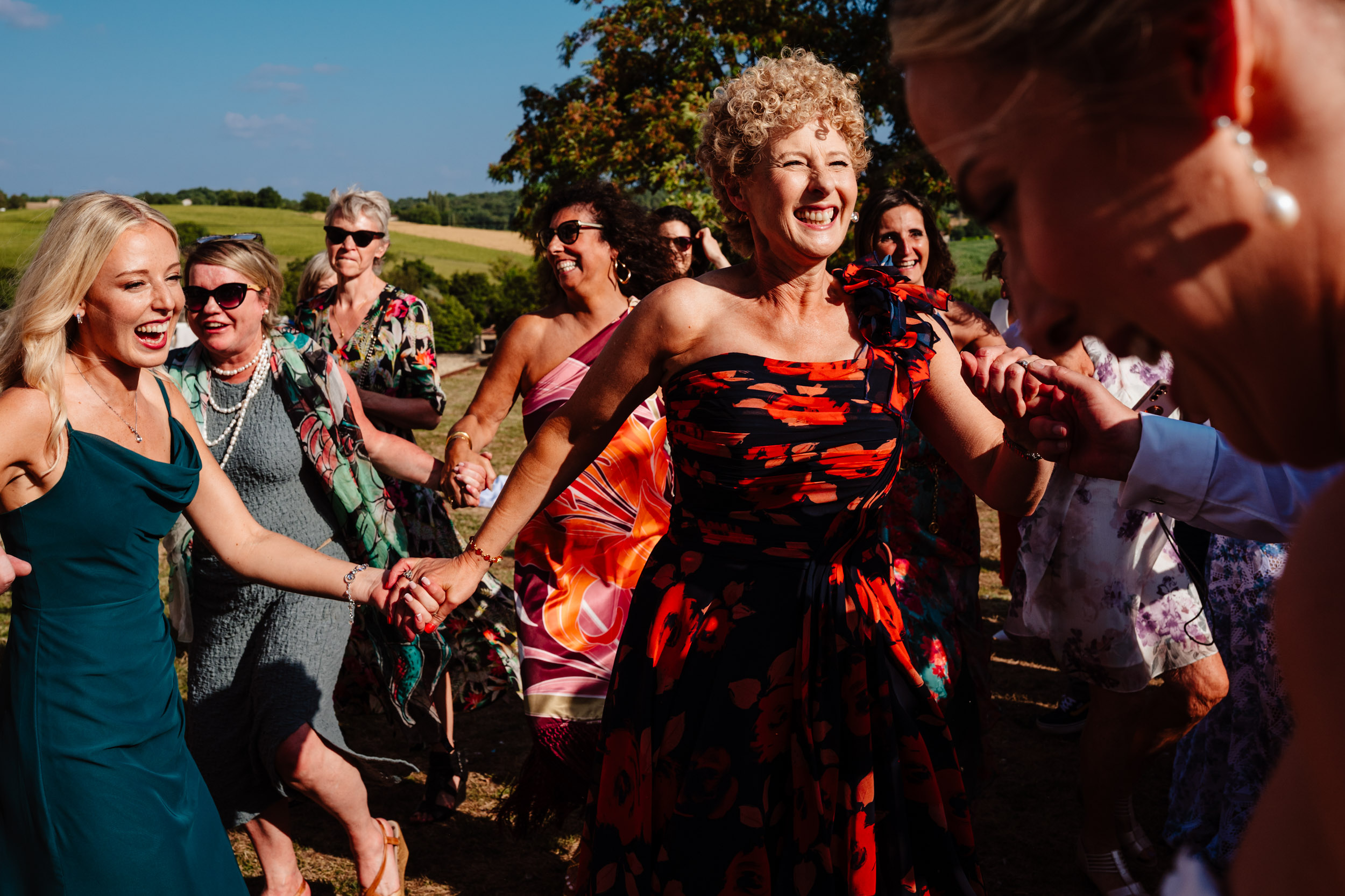 Wedding party dancing together in a circle during the celebrations
