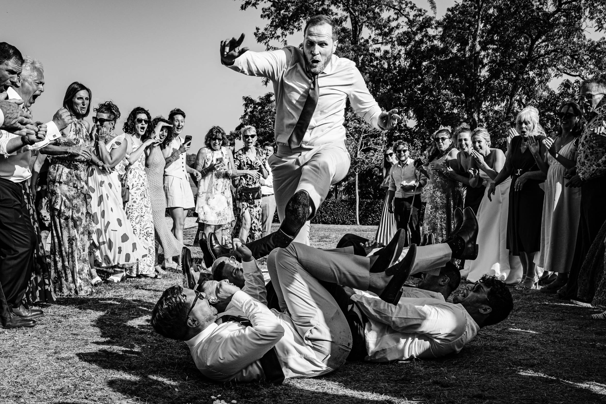 Groom jumping over guests as part of traditional Israeli wedding dancing