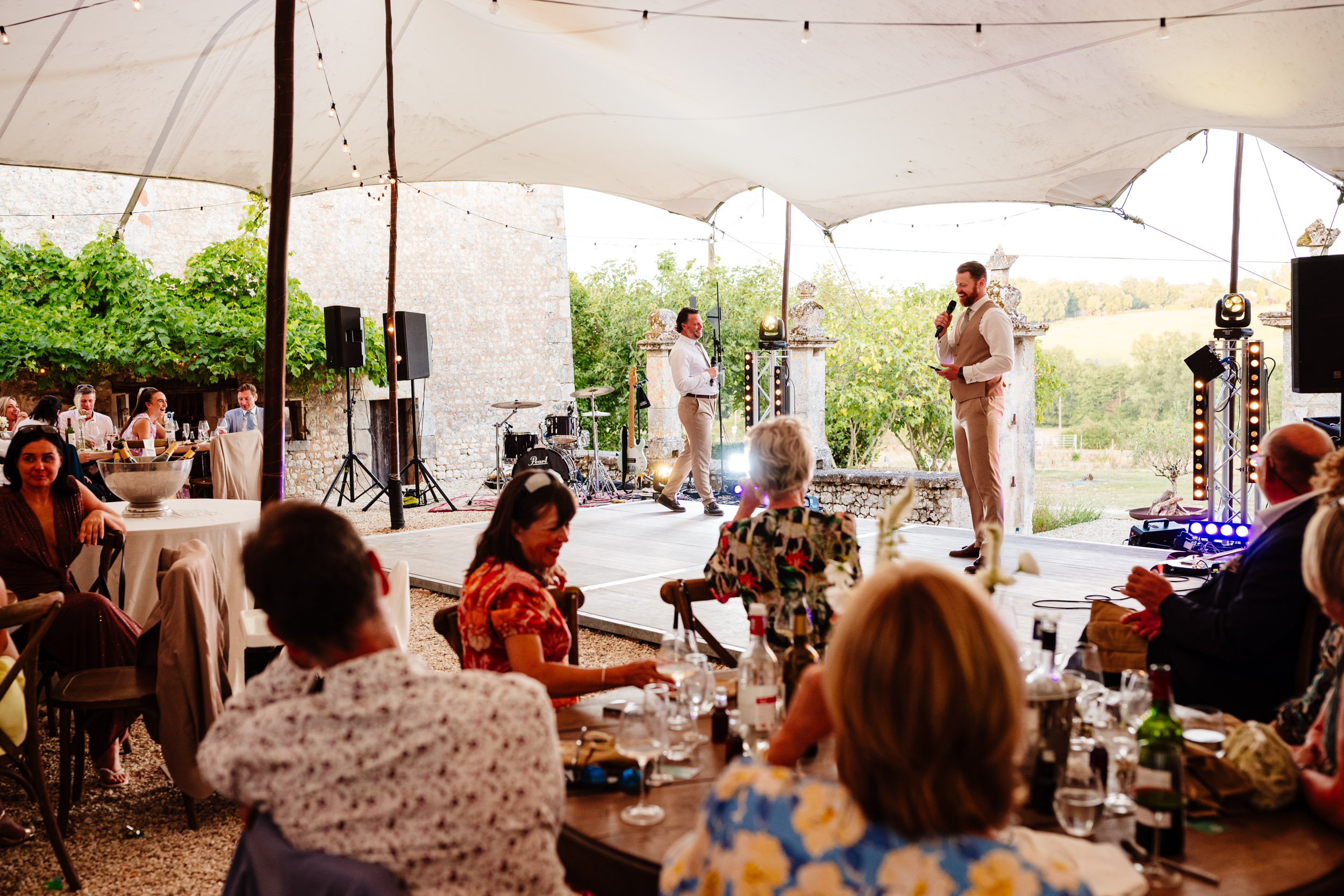 Best man and groomsman delivering speeches to the room