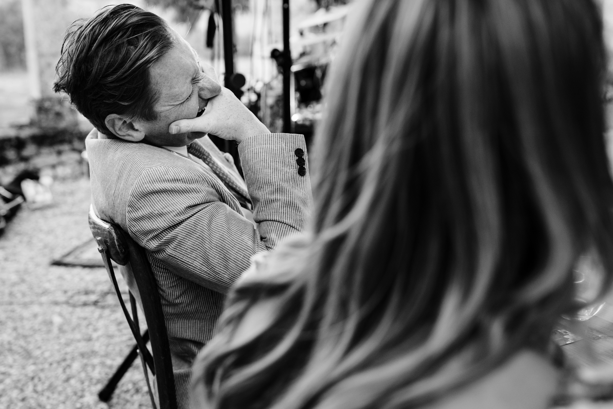 Wedding guest reacting with a big belly laugh during the speeches