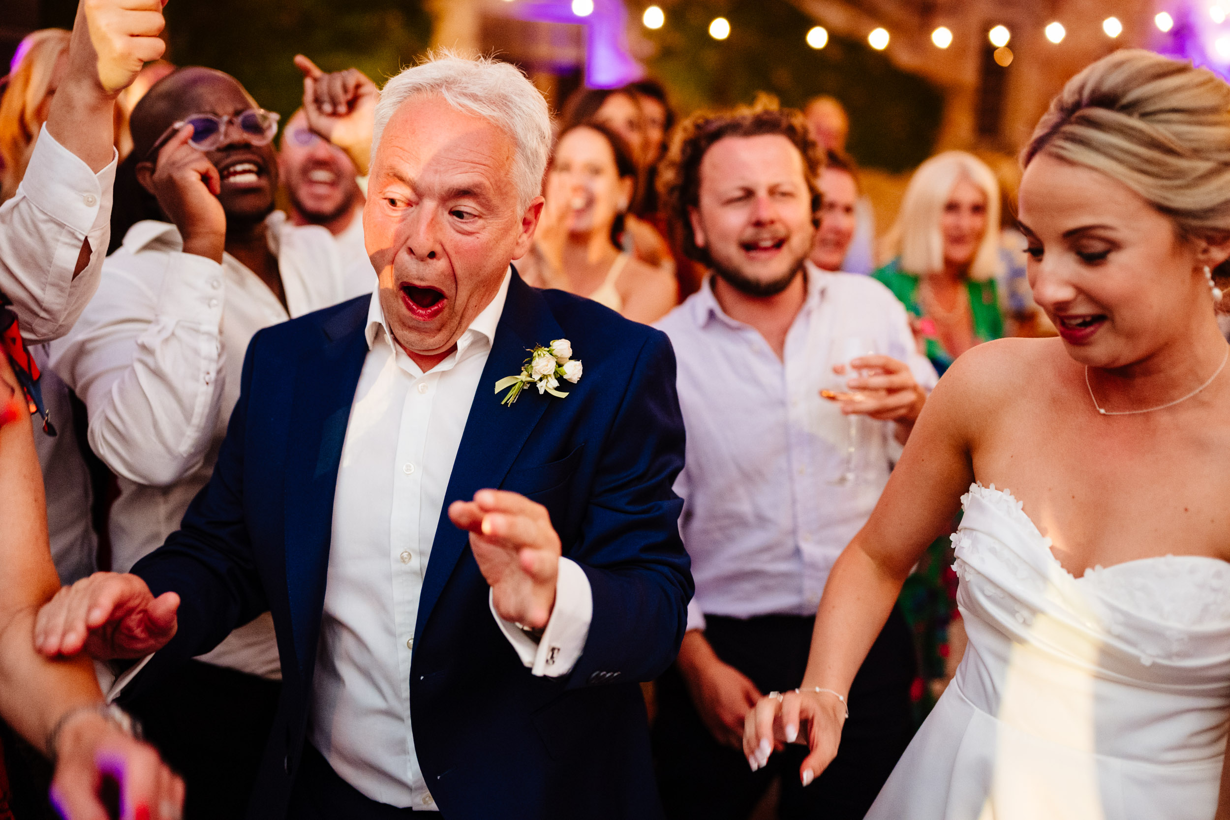 Bride’s dad pulling a cheeky face while dancing on the dance floor
