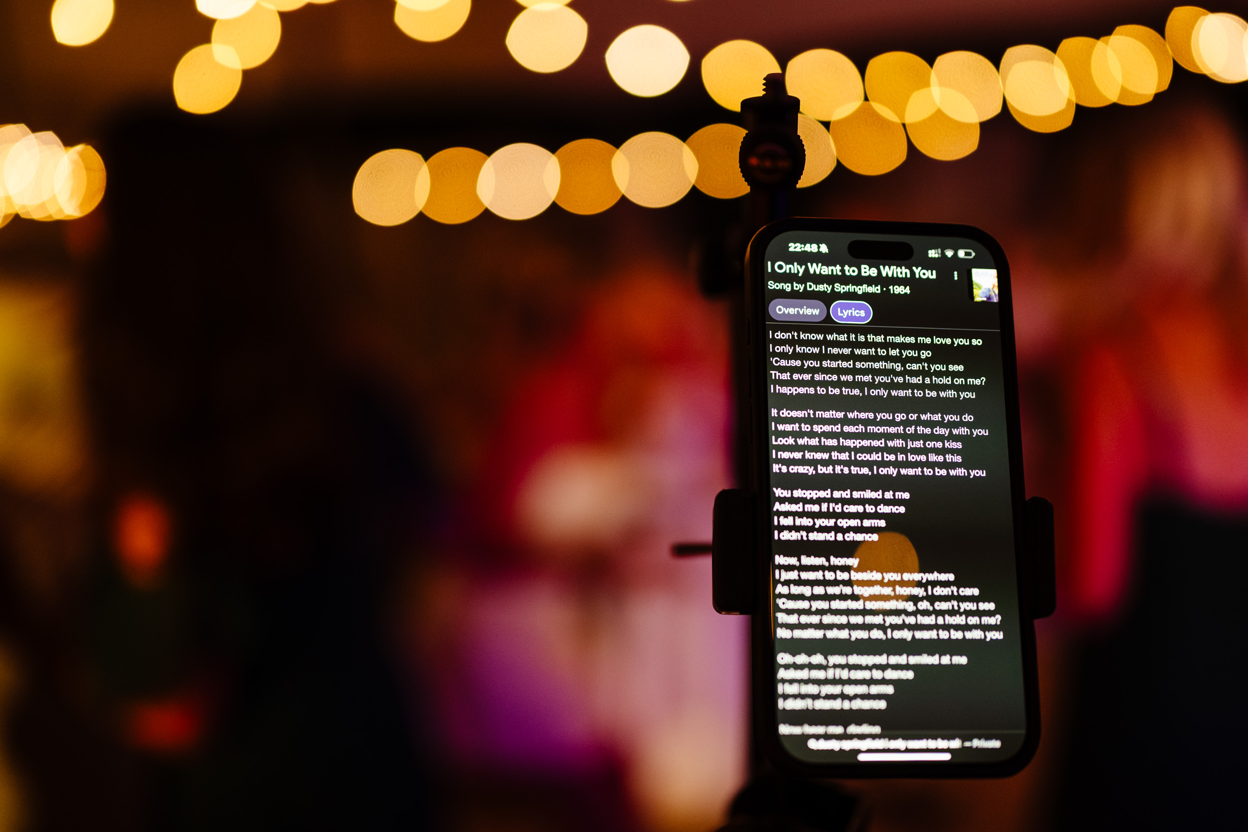 Close-up of song lyrics displayed on a phone used by the band