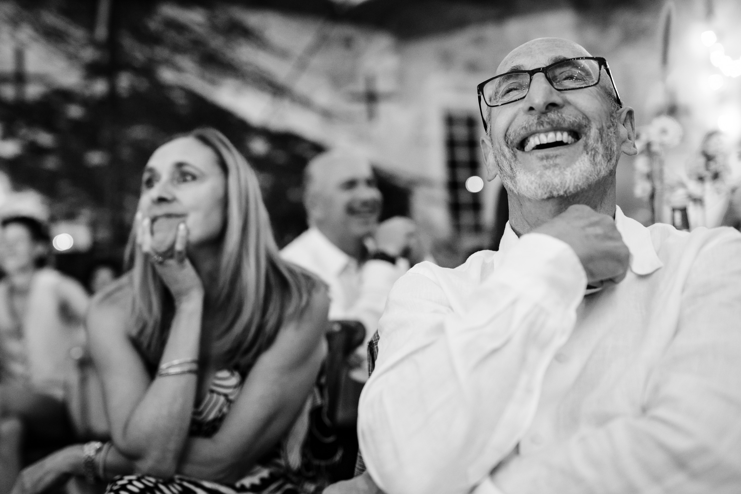 Wedding guest reacting and laughing at the action on the dance floor