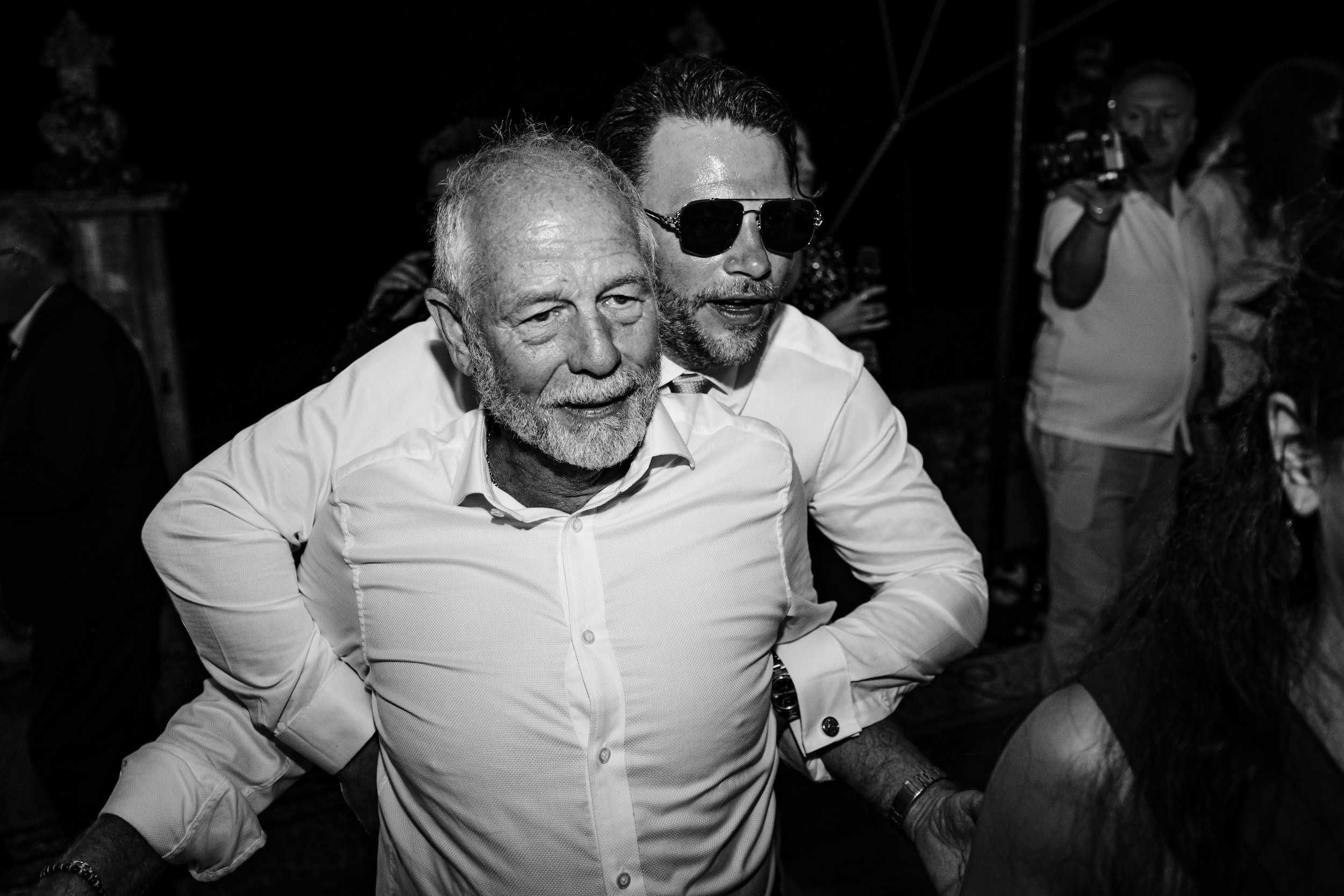 Best man dancing with the groom’s dad during the evening celebrations