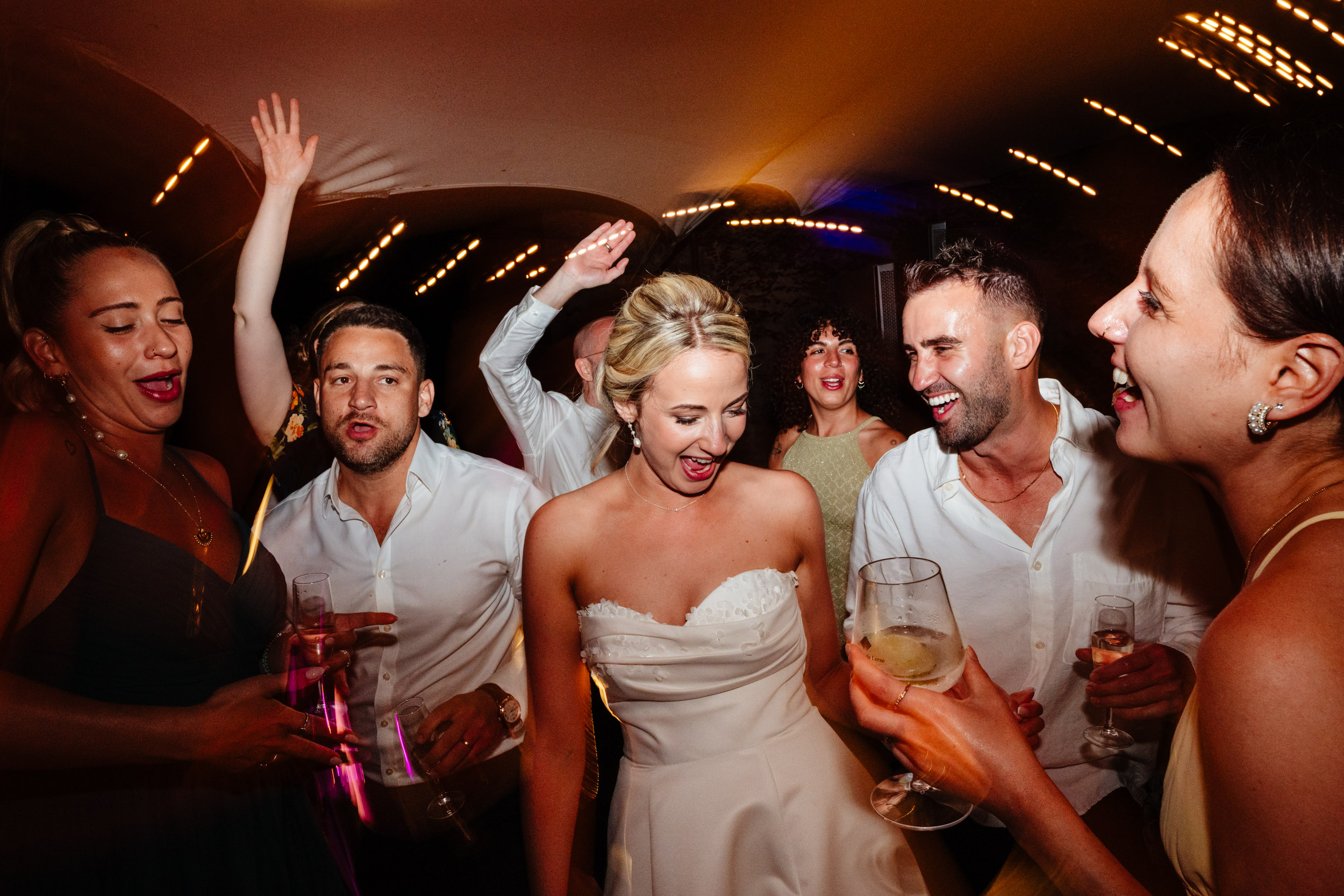 Bride dancing with her bridal party on the dance floor