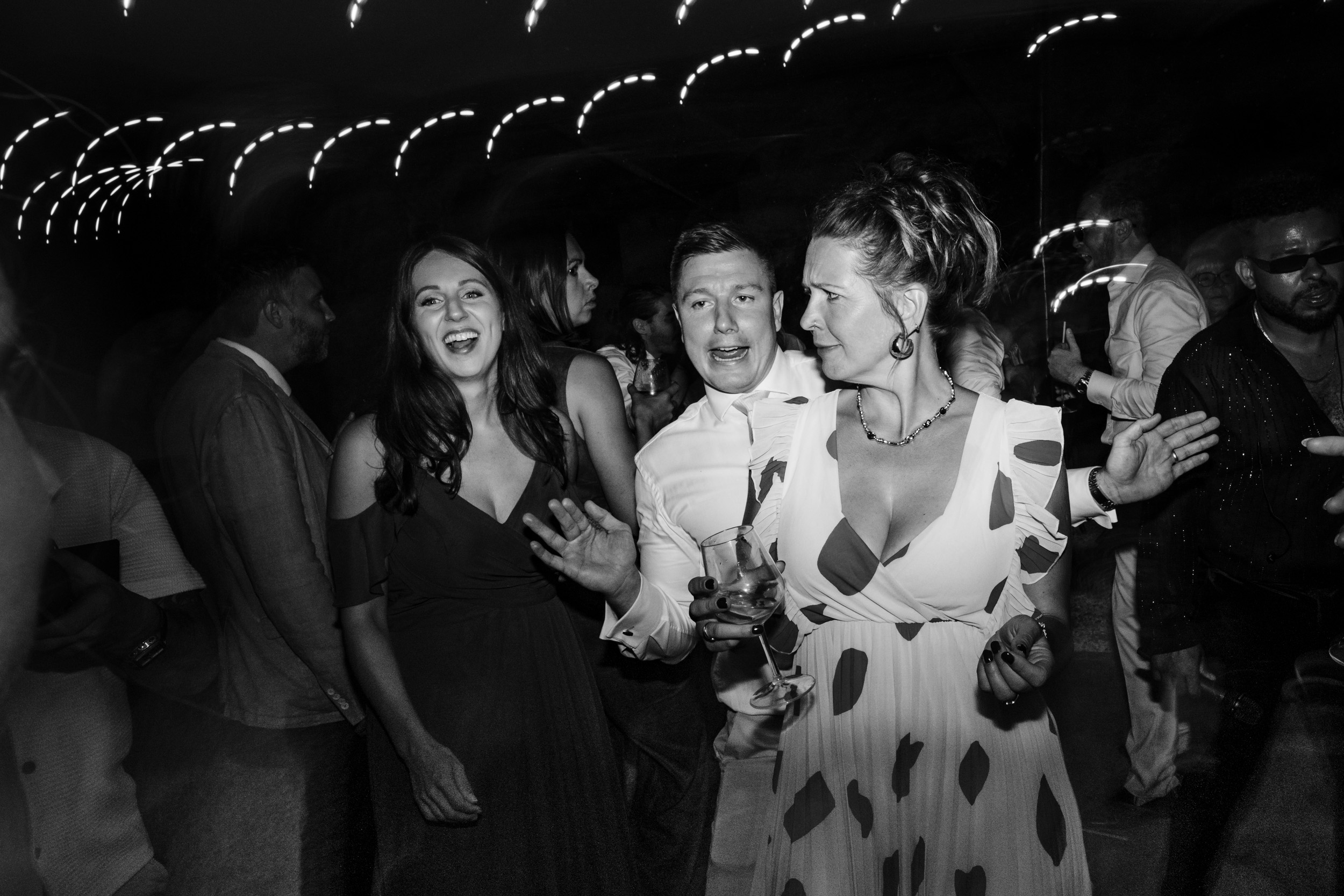 Wedding guest being cheeky with another guest during the evening celebrations