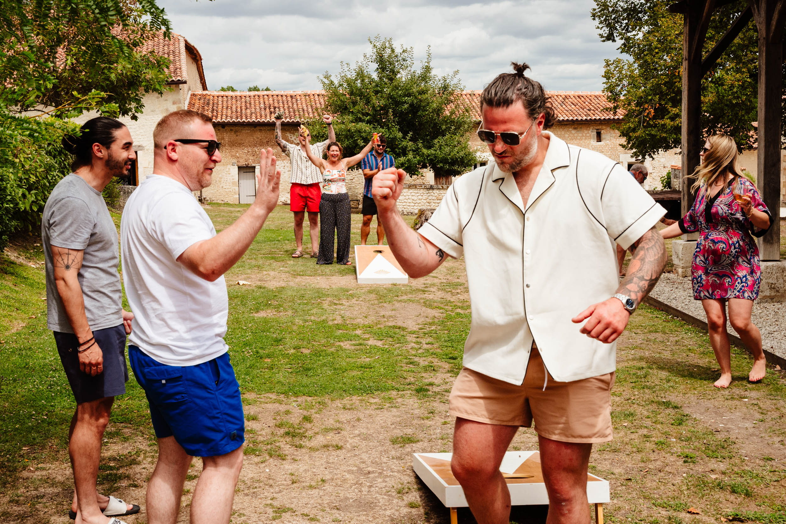 Wedding guests playing garden games during the pool party