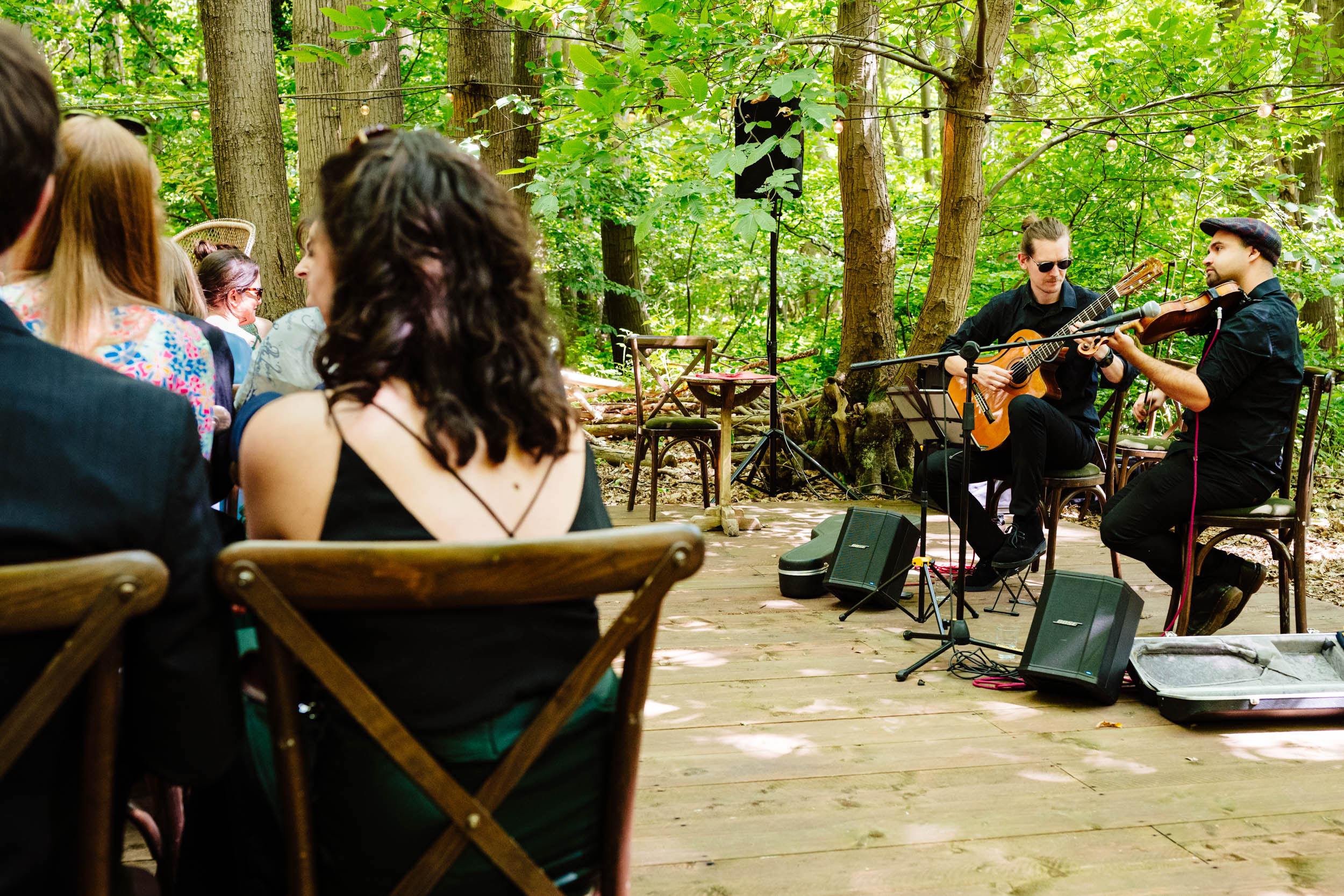Wedding ceremony setup focused on musicians playing guitar