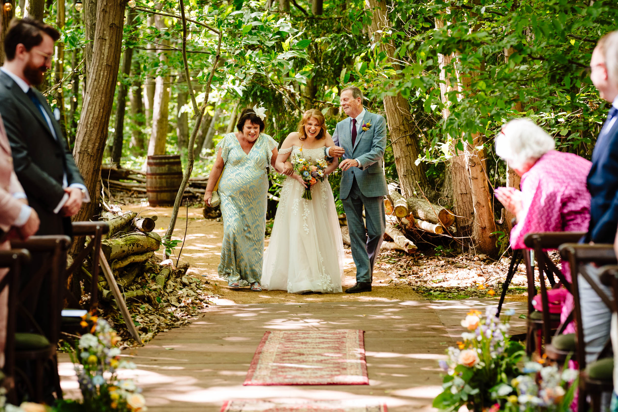 Bride being walked down the aisle by her mum and dad at The Dreys wedding ceremony