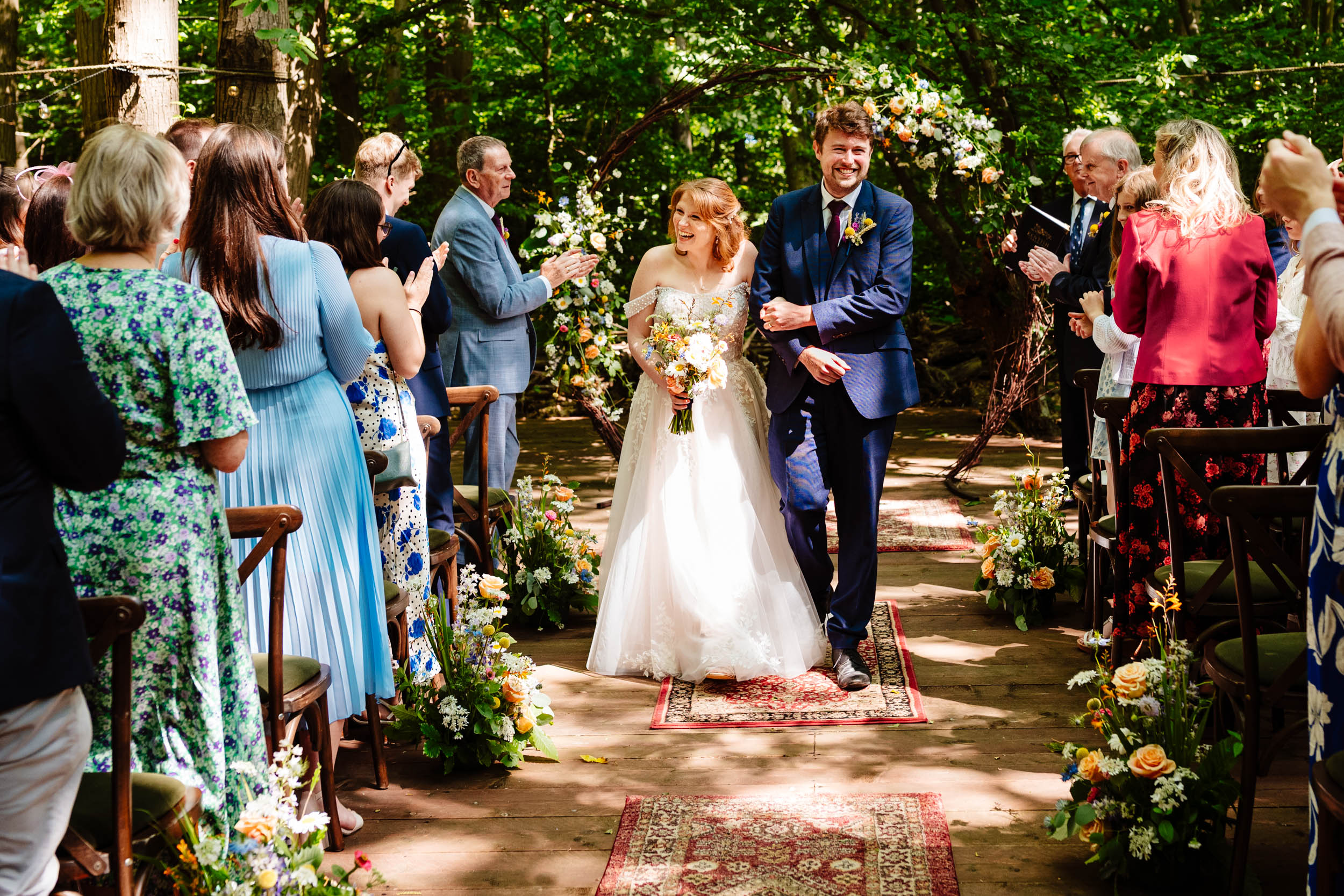 Bride and groom walking back down the aisle together after getting married