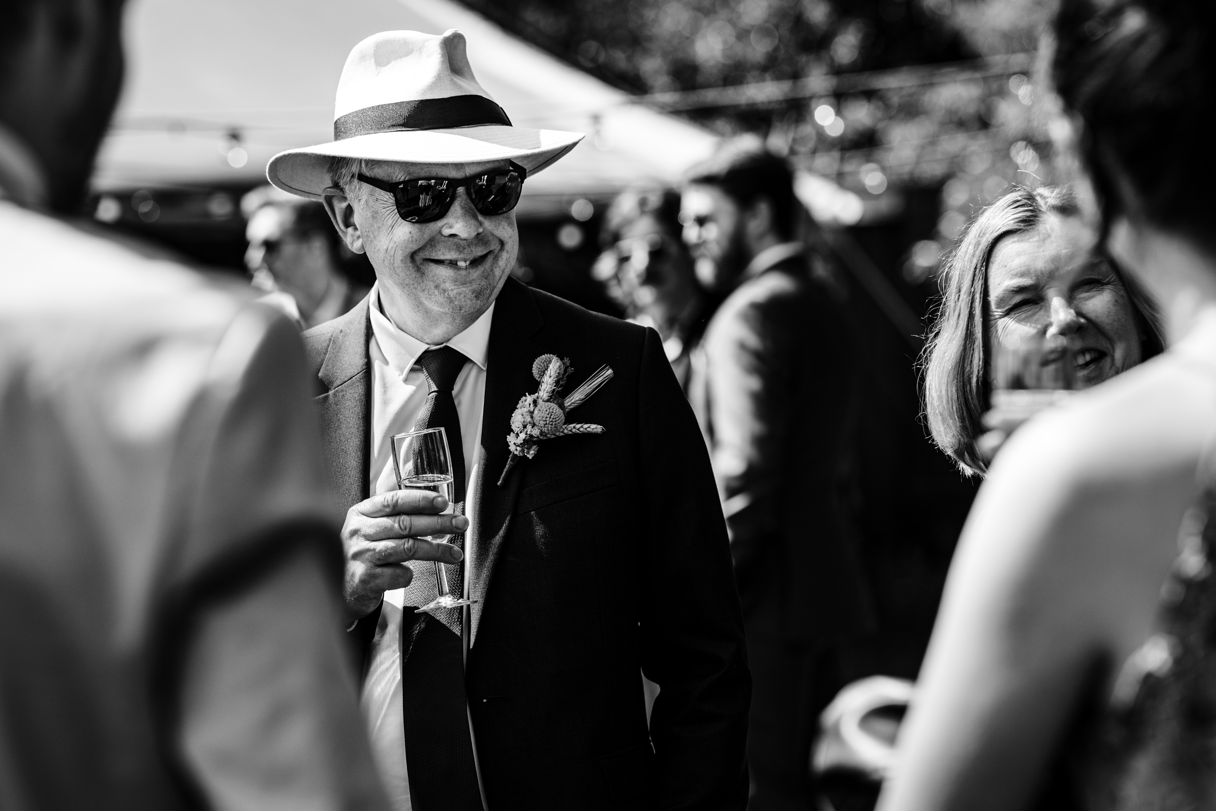 Groom’s dad wearing a hat and smiling during the wedding celebrations