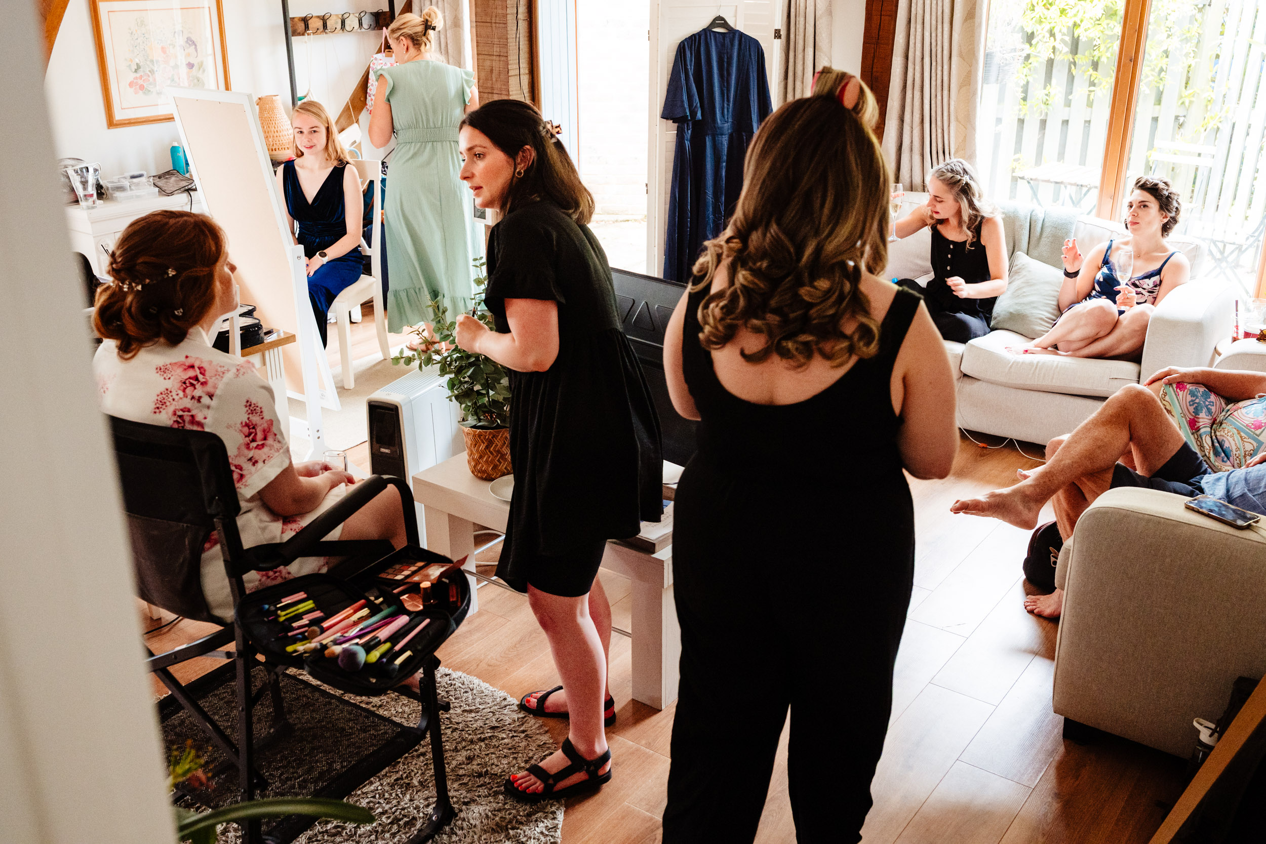 Busy scene of the bridal party getting ready together on the wedding morning