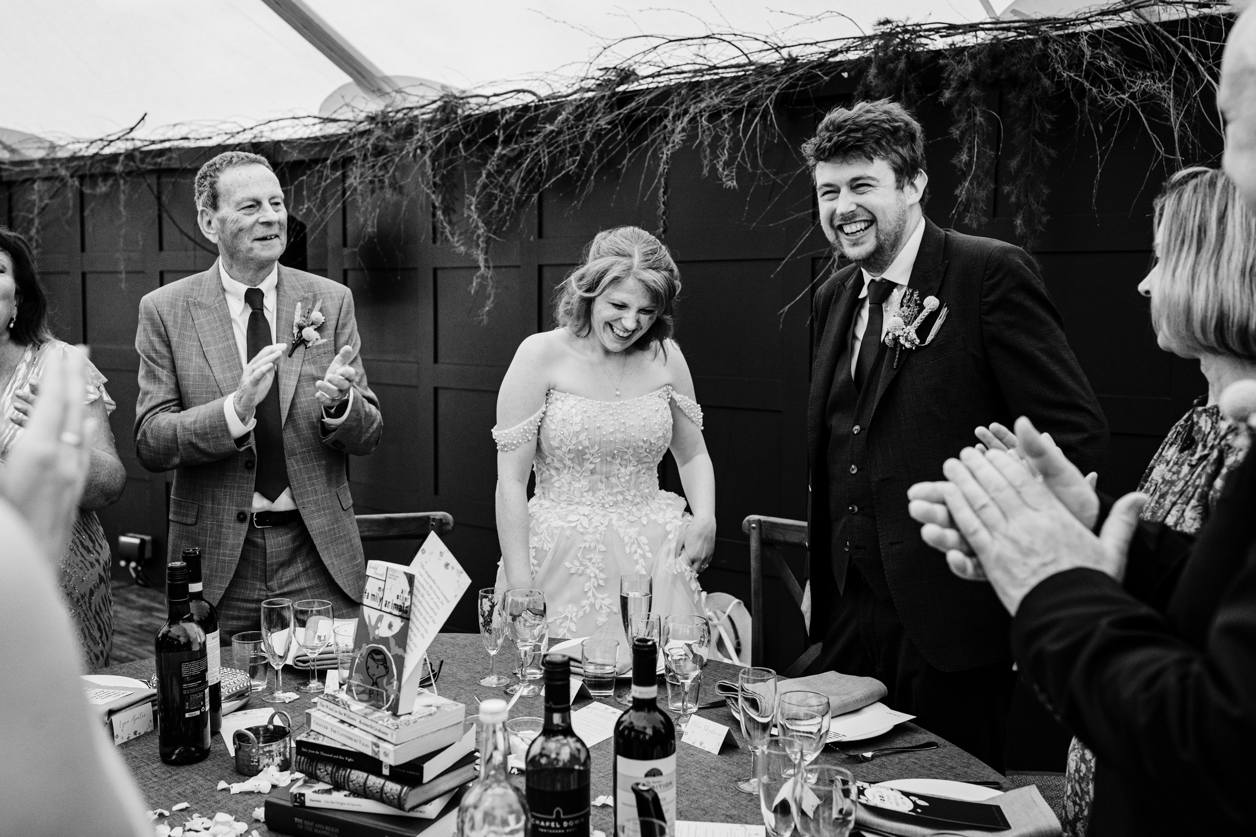 Bride and groom arriving at the top table just after entering the dining area