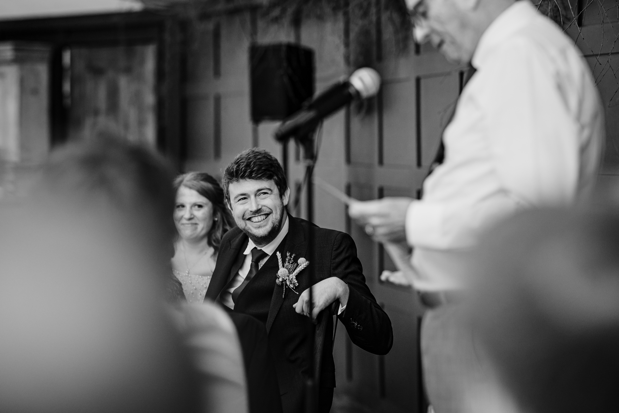 Bride and groom listening during the bride’s dad’s speech