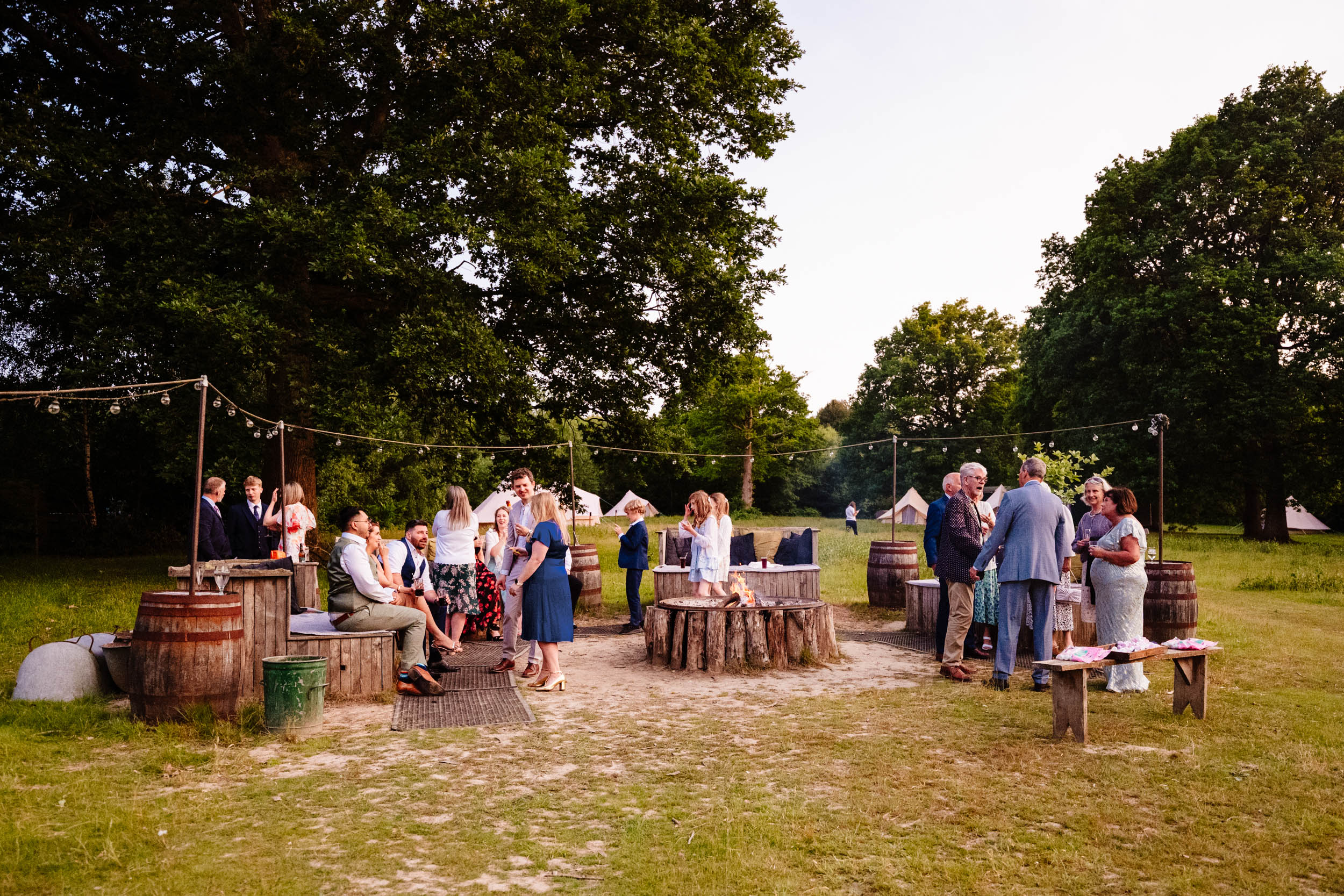 Wedding guests chatting outside in the grounds of The Dreys