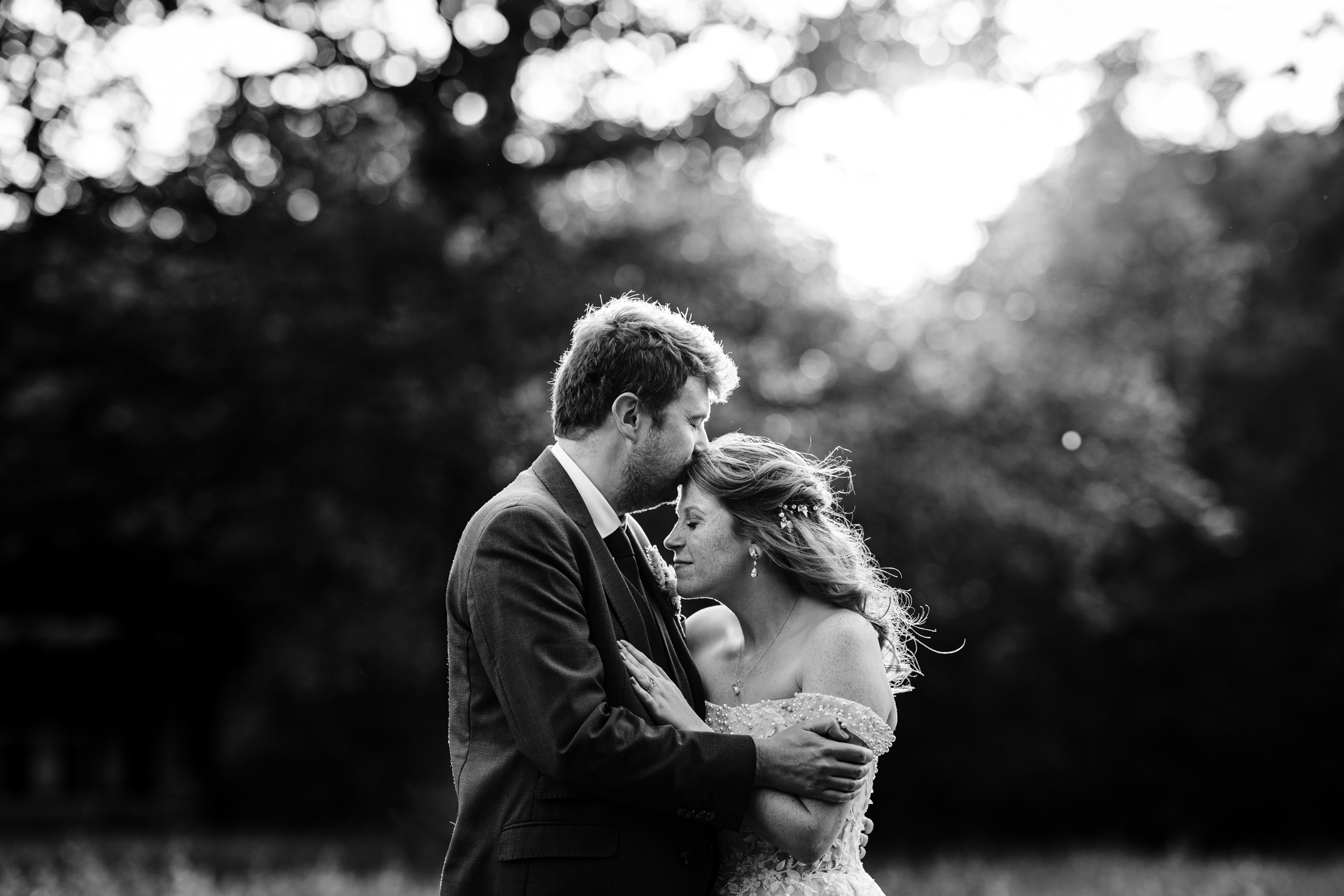Groom kissing the bride on the head during an intimate couple moment
