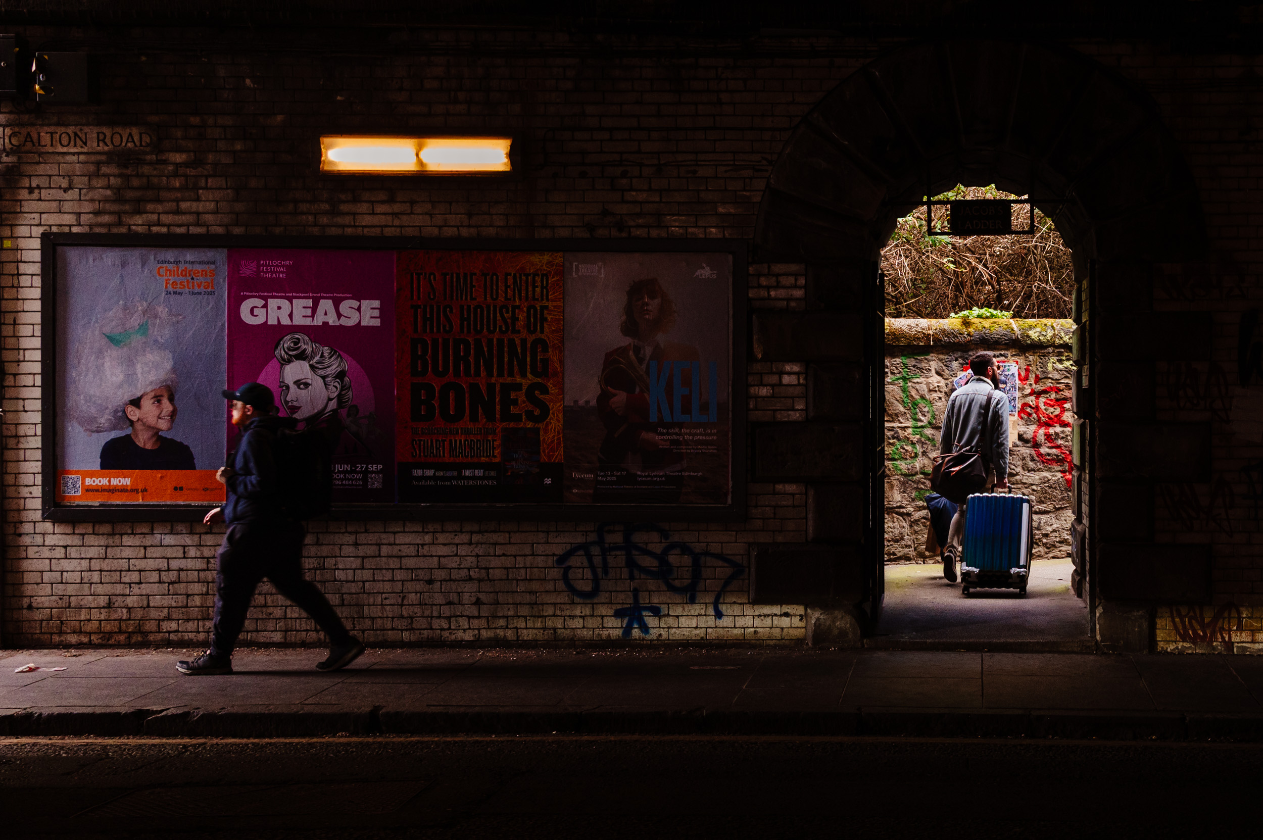 Two guys walking out opposite ends of a tunnel.