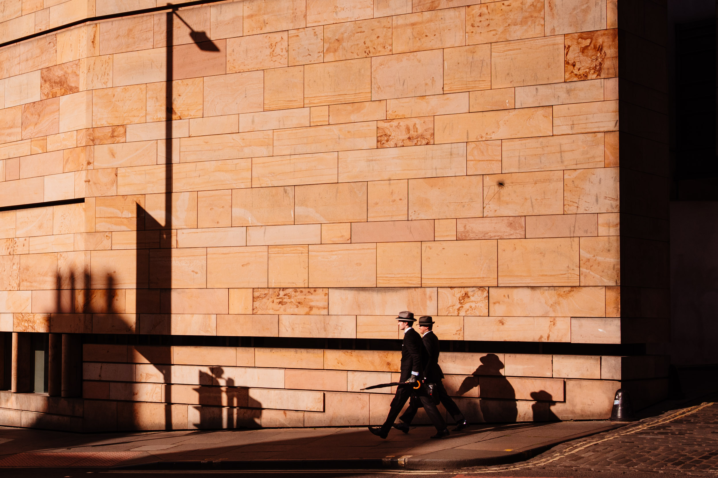 Two gentlemen walking down a street in Edinburgh.
