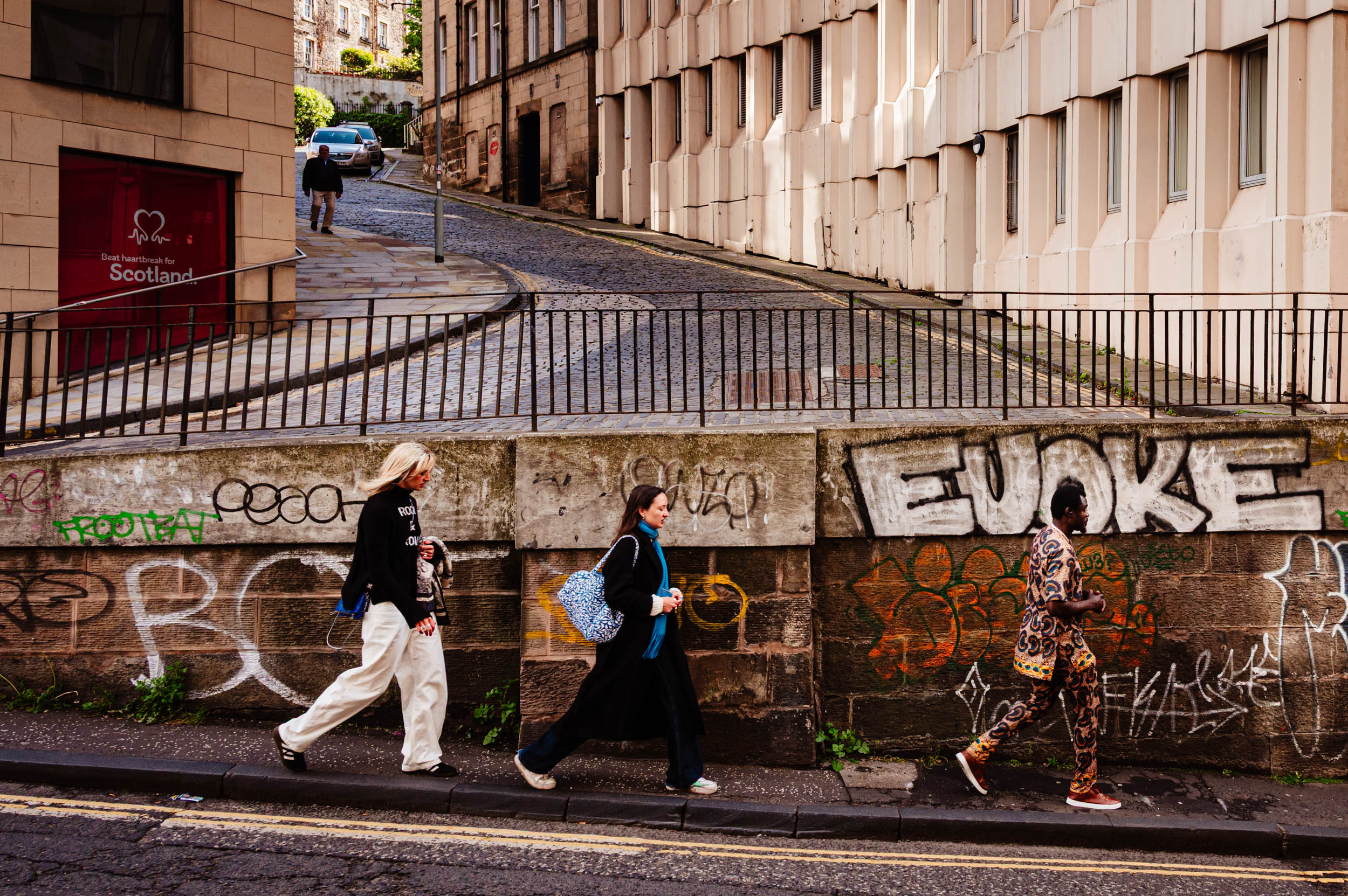 People walking down a street in Edinburgh.