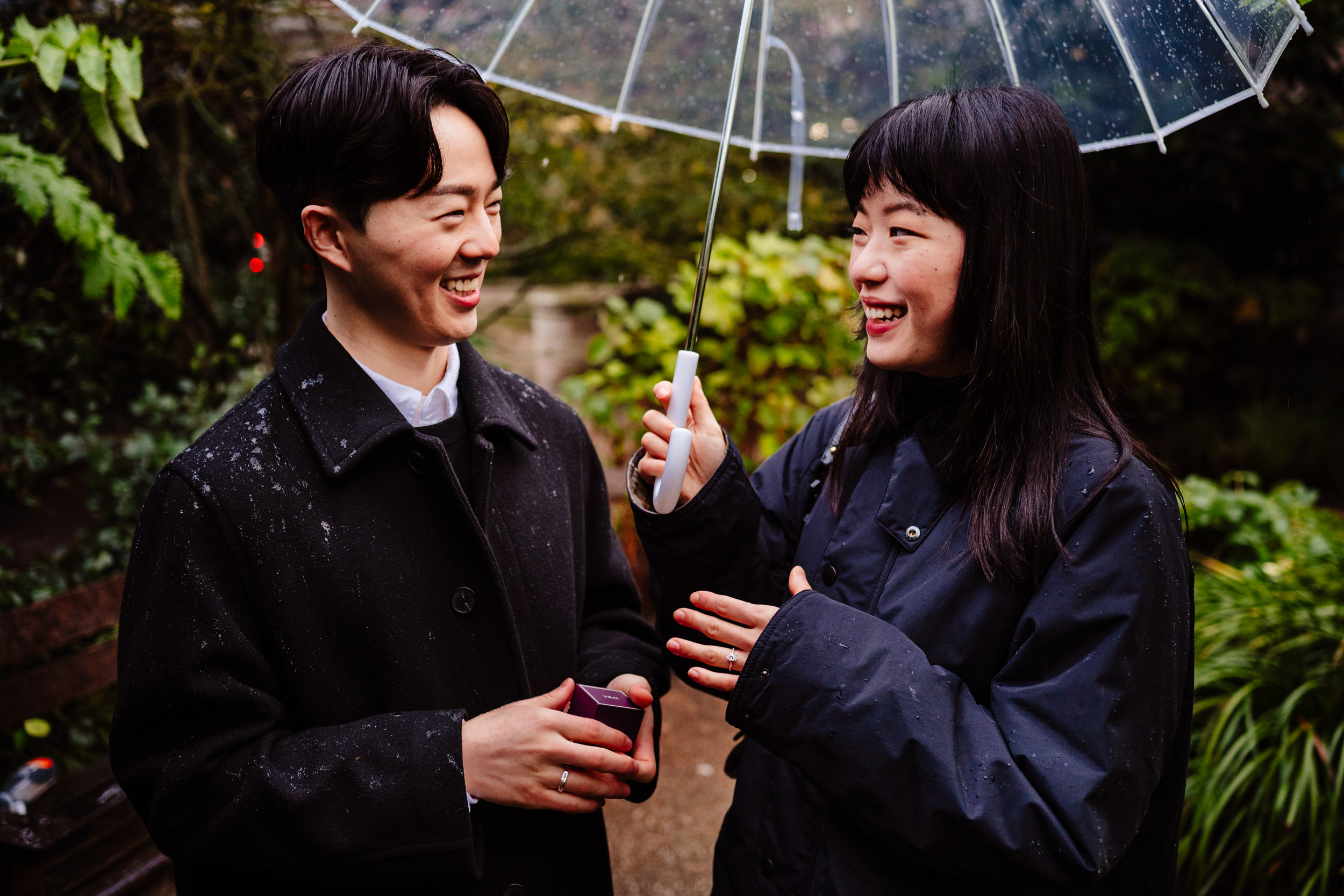 Engaged couple laughing together outside St Paul’s Cathedral after the surprise proposal.