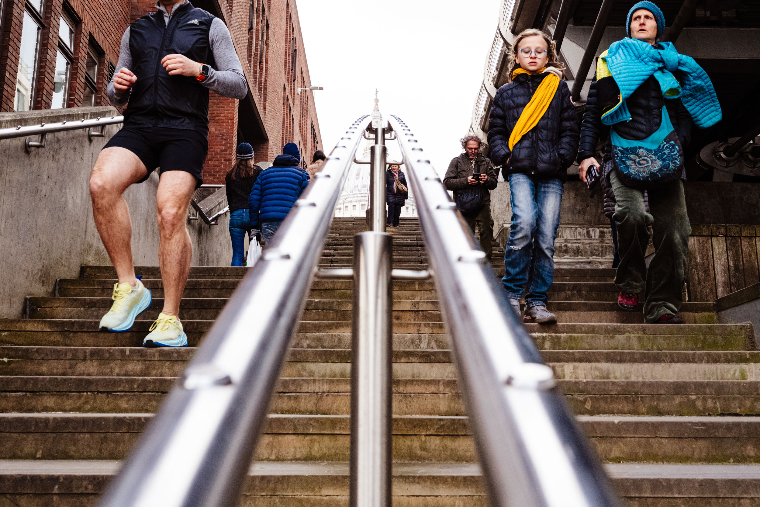 People coming down a staircase near St Paul's Cathedral in London.