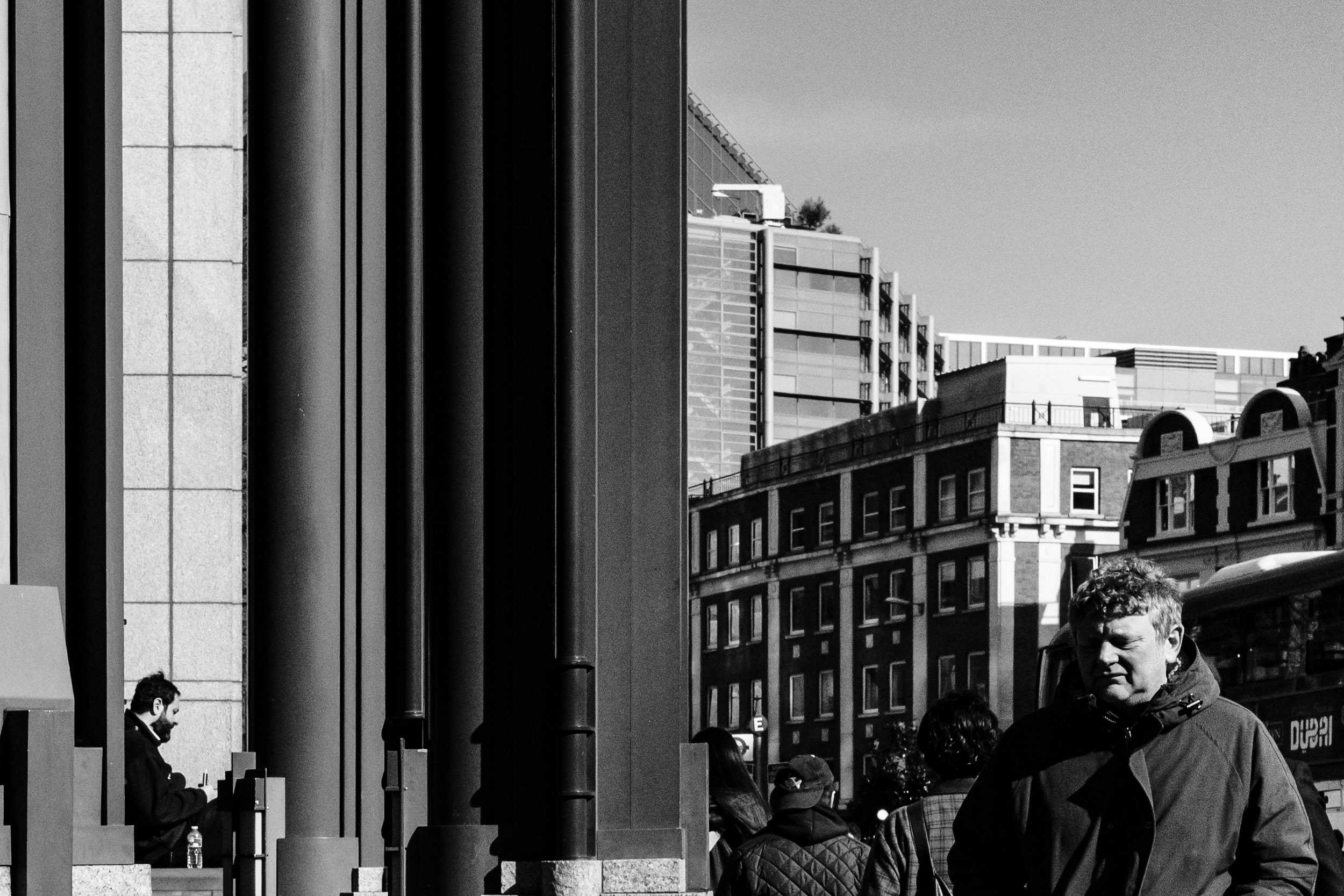 A street in London - two men on each side of the frame.