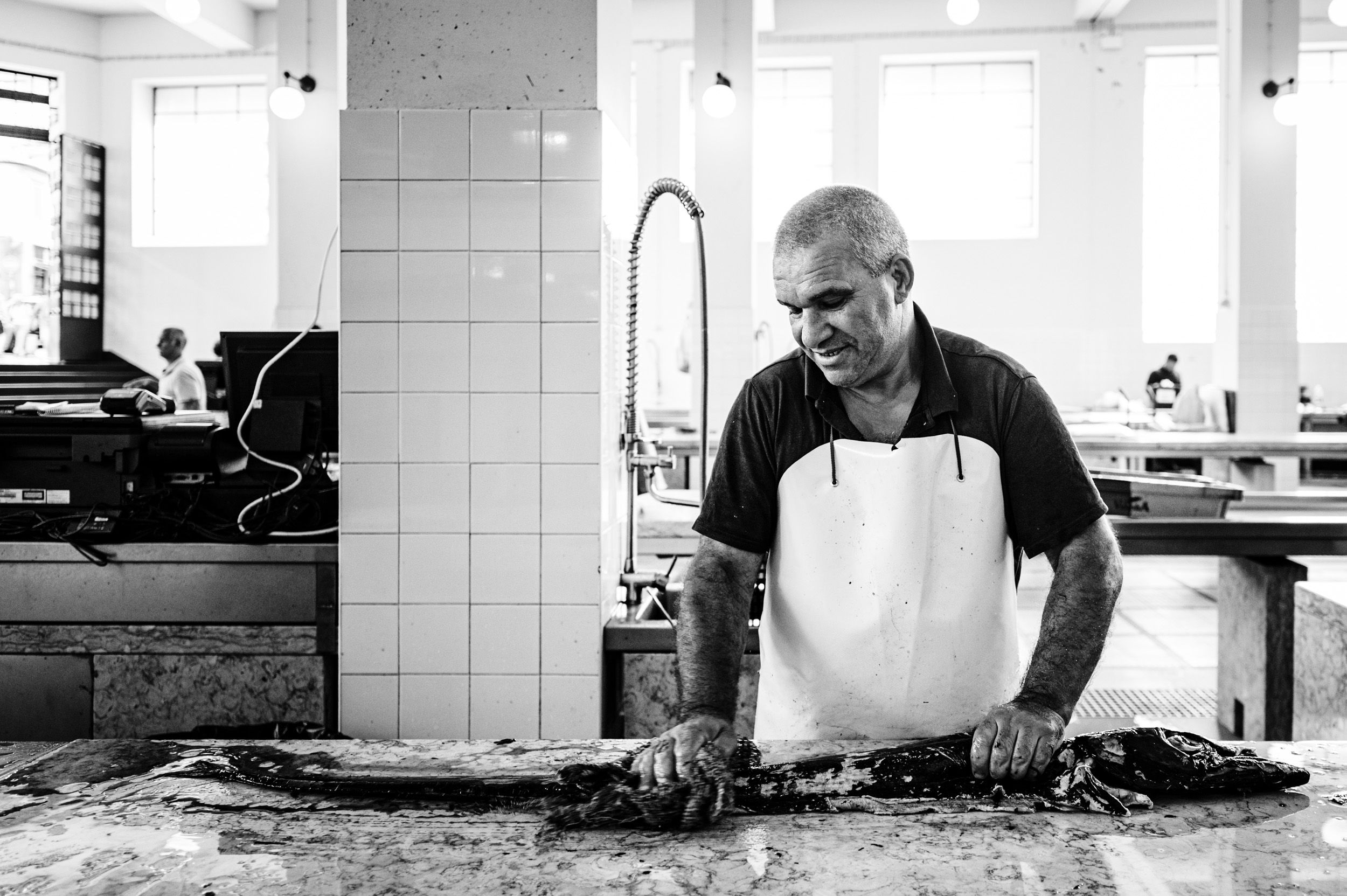 A man cleaning a fish in the market in Funchal