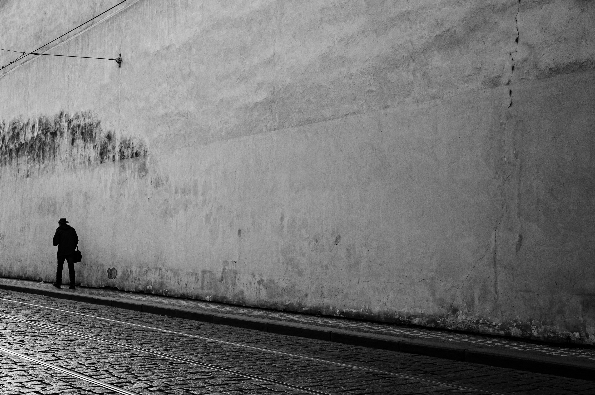 Man walking down on a quiet, empty street.