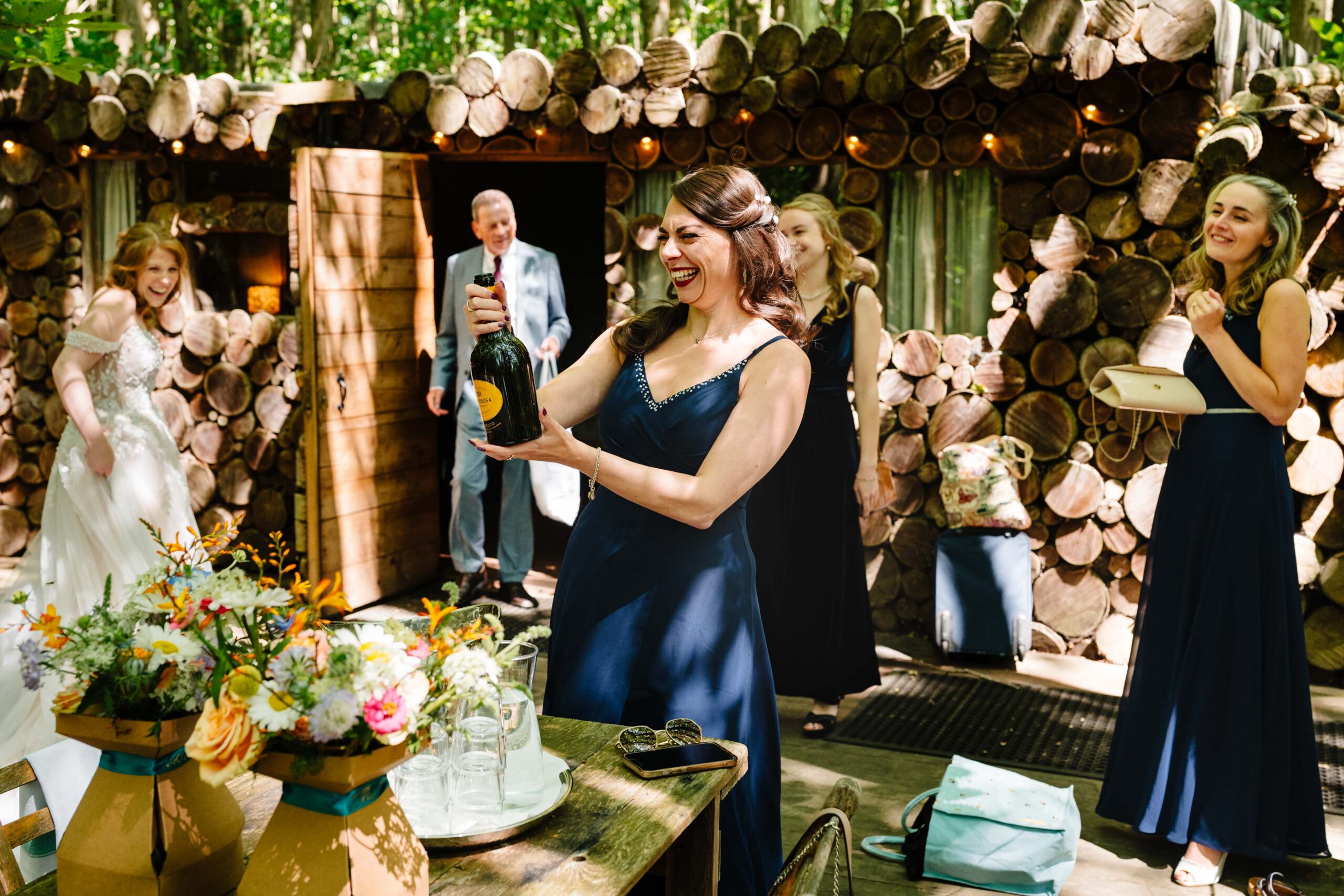 Bridesmaids walking through the woodland ceremony area at The Dreys in Kent.