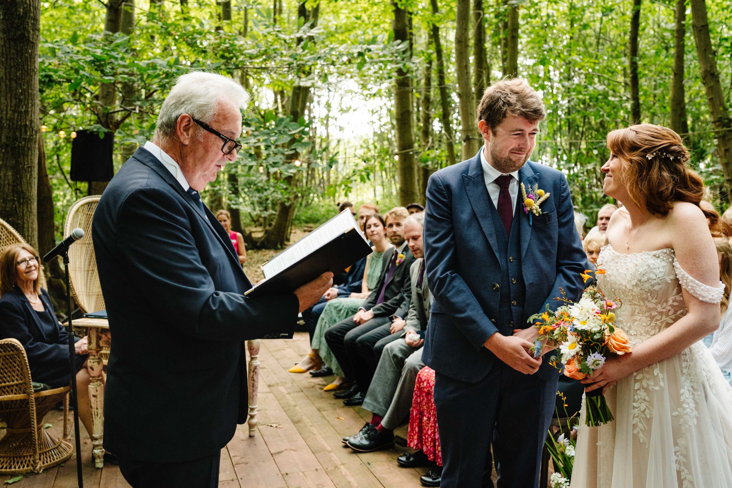 Wedding ceremony taking place in the woods at The Dreys wedding venue.