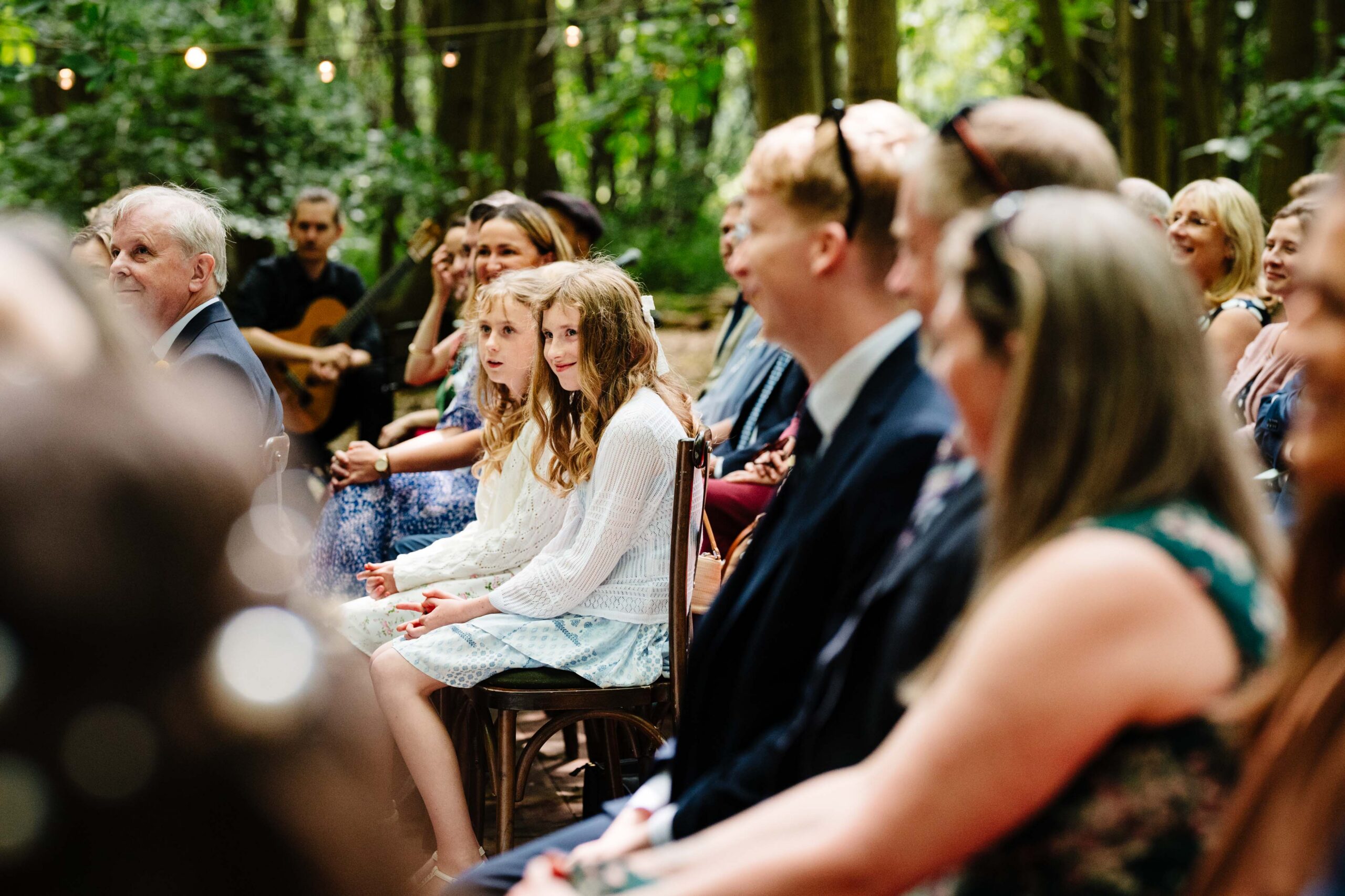 Guests watching an emotional woodland wedding ceremony at The Dreys.