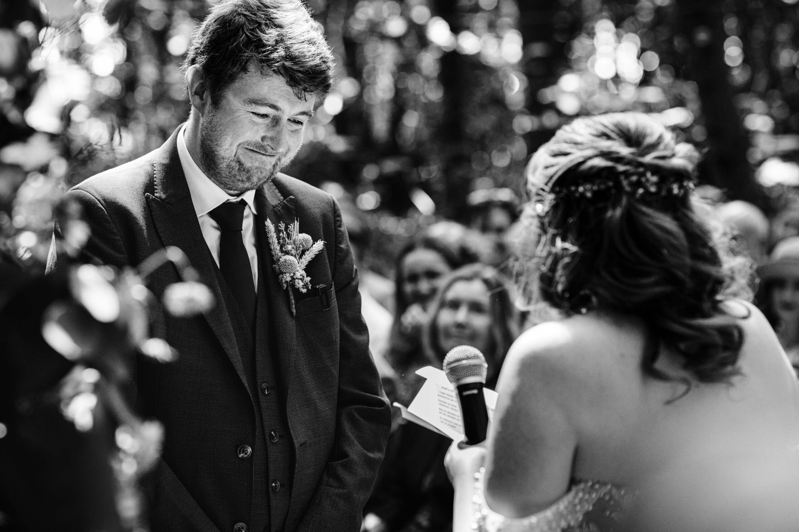 Bride and groom exchanging vows during a woodland wedding ceremony in Kent.