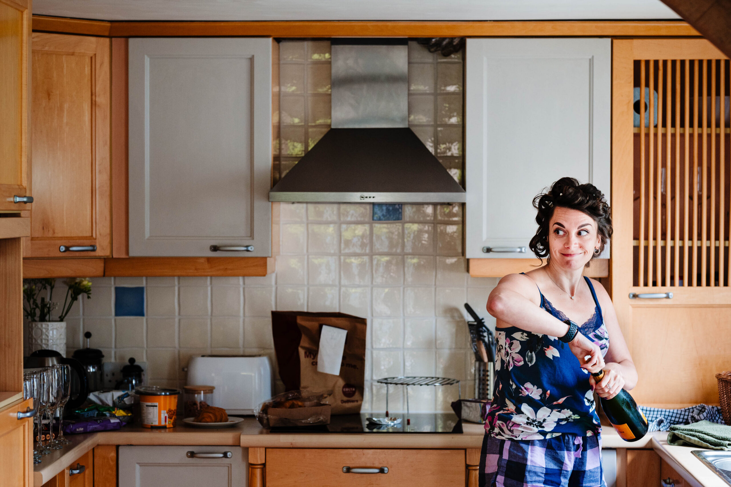 Bride smiling in the kitchen while getting ready for her woodland wedding at The Dreys.