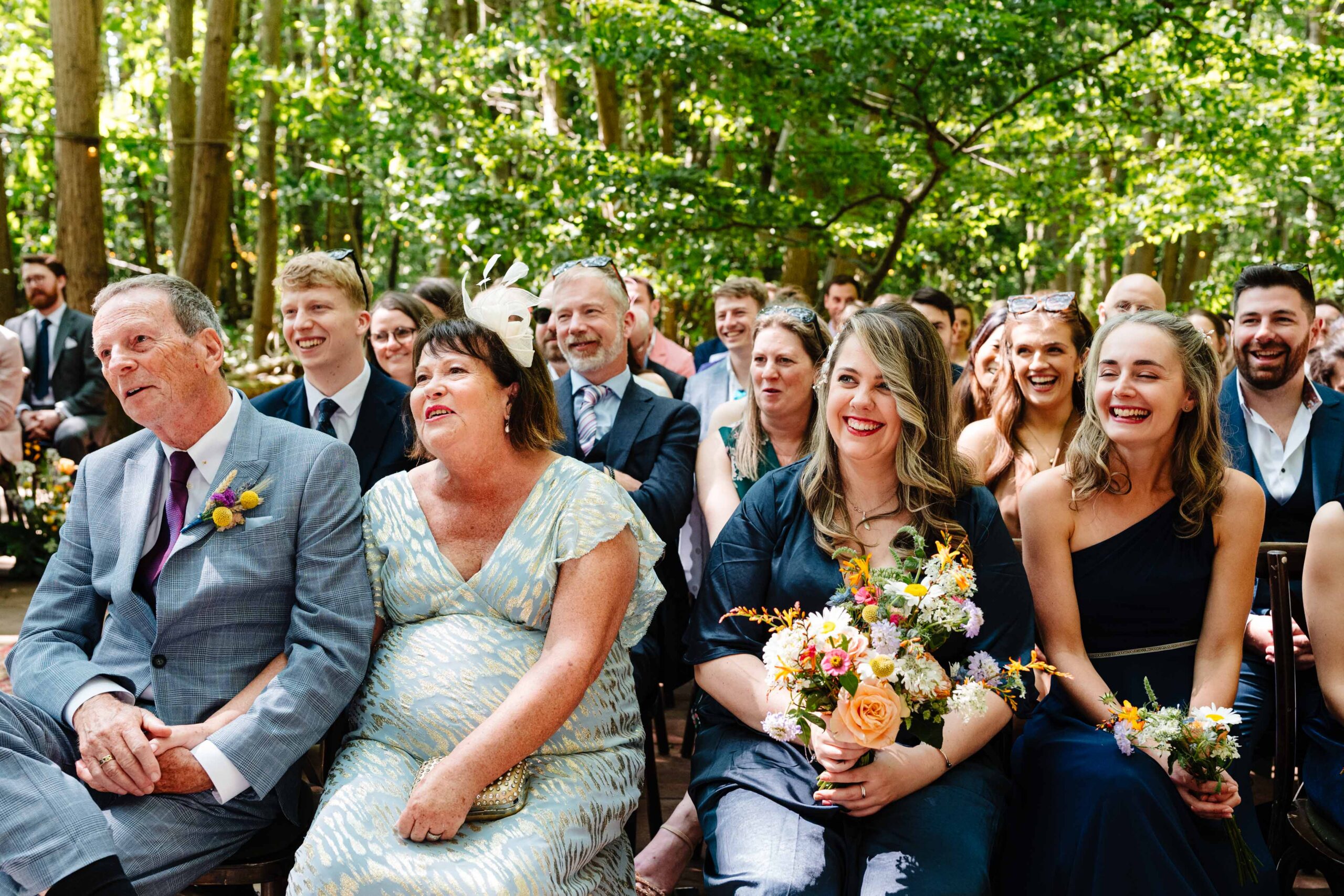 Wedding guests smiling during a relaxed outdoor ceremony at The Dreys.