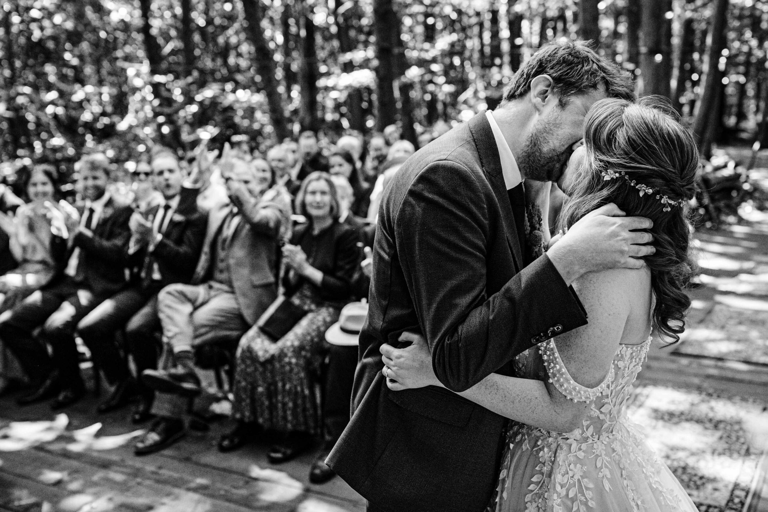 Bride and groom sharing their first kiss after the ceremony at The Dreys.