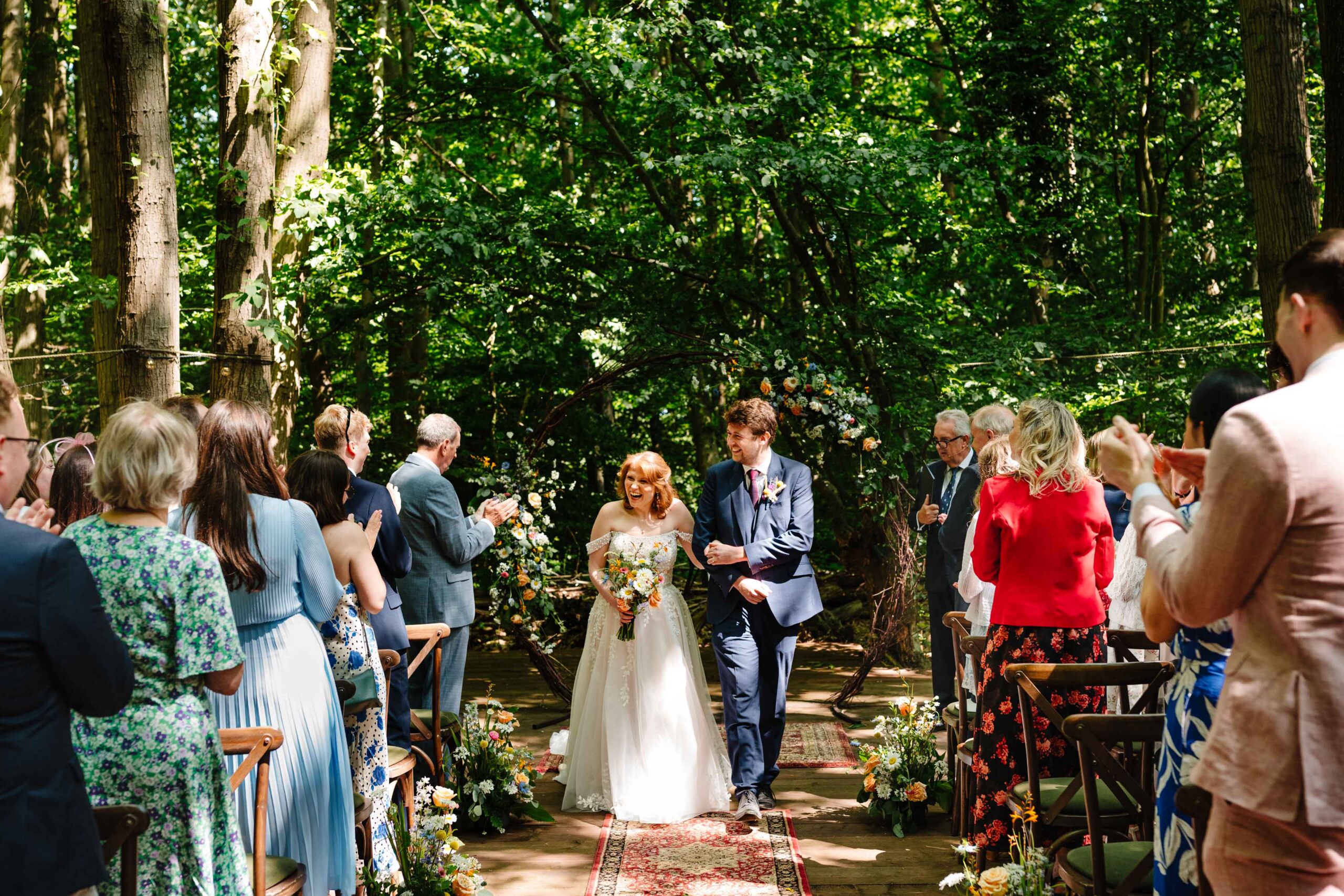 Bride and groom walking through guests after their wedding ceremony at The Dreys.