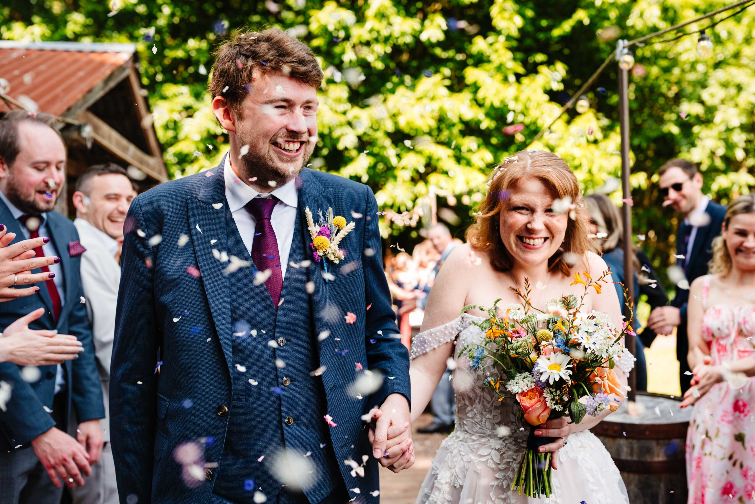 Bride and groom celebrating their confetti exit at The Dreys in Kent.