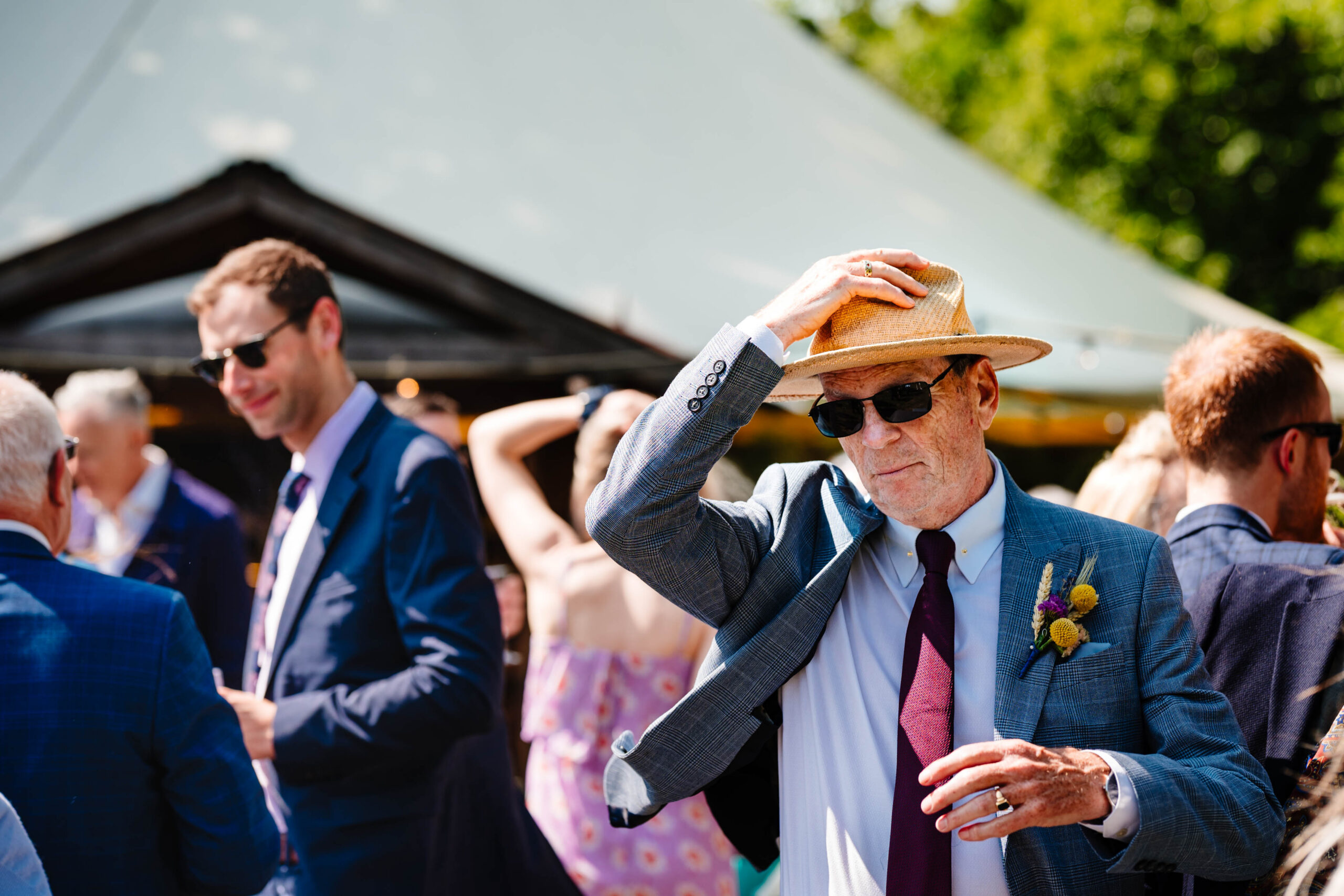 Wedding guest enjoying a sunny drinks reception at The Dreys wedding venue.