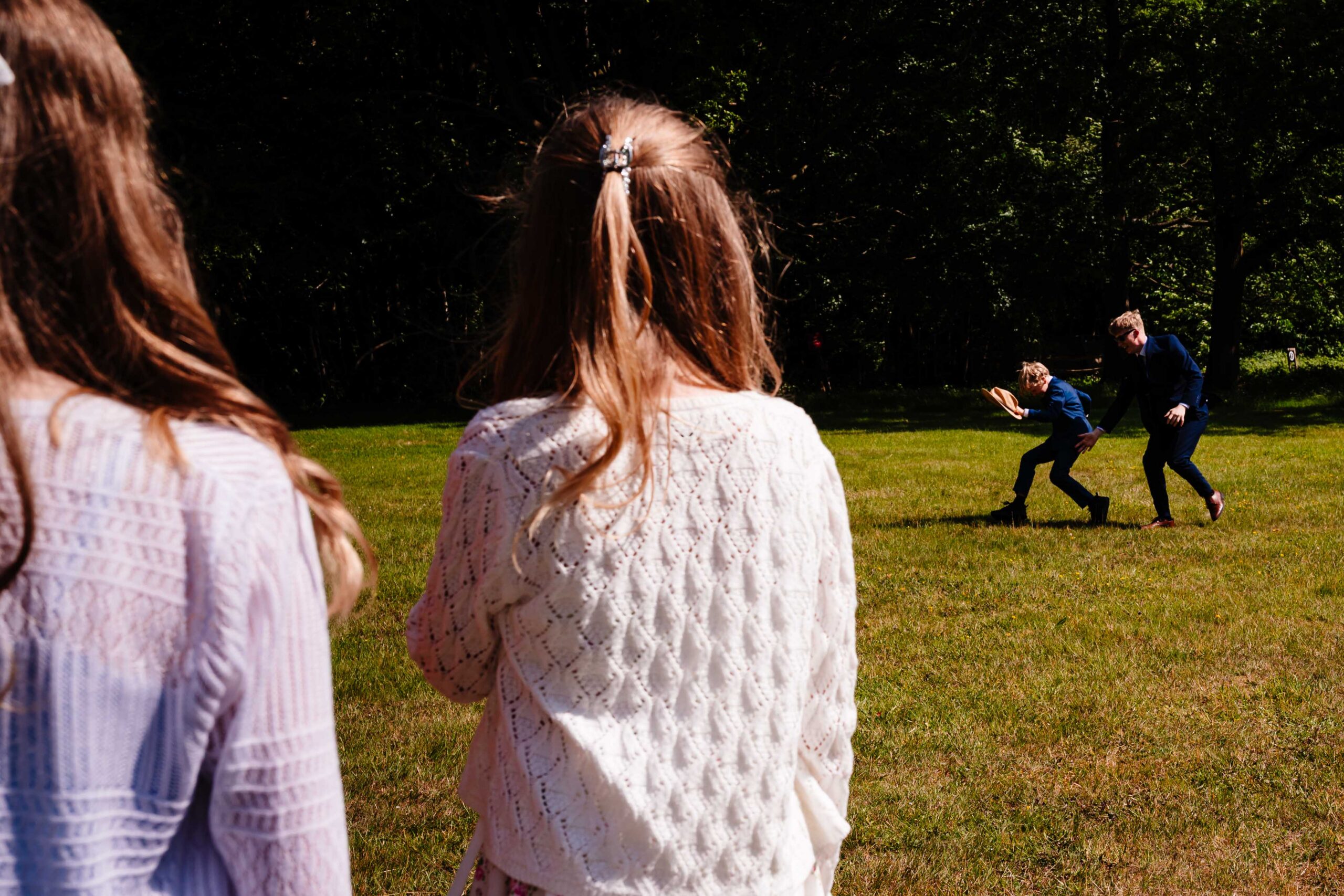 Guests chatting on the lawn during a relaxed wedding reception at The Dreys.