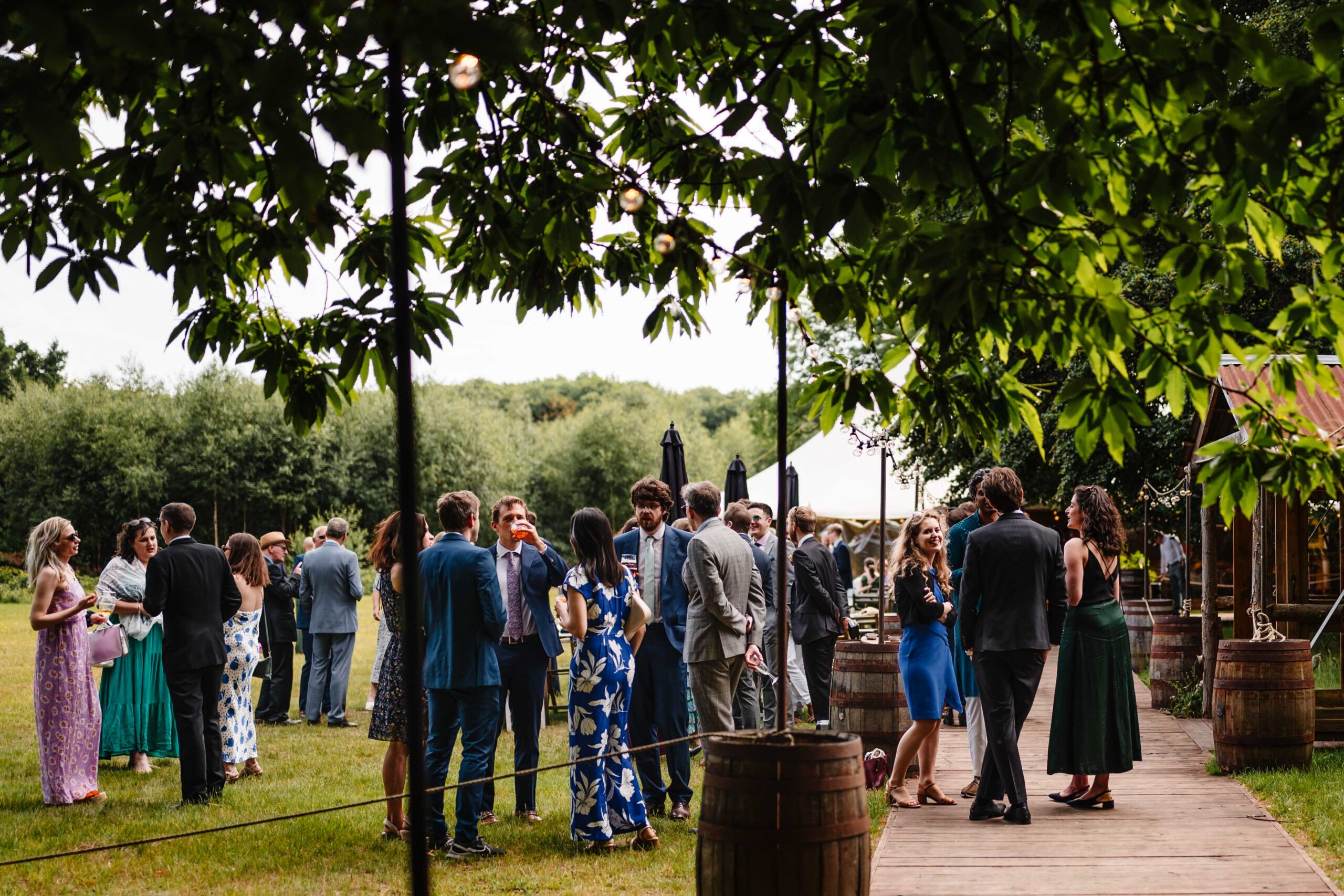 Guests gathering outdoors during a summer wedding reception in Kent.