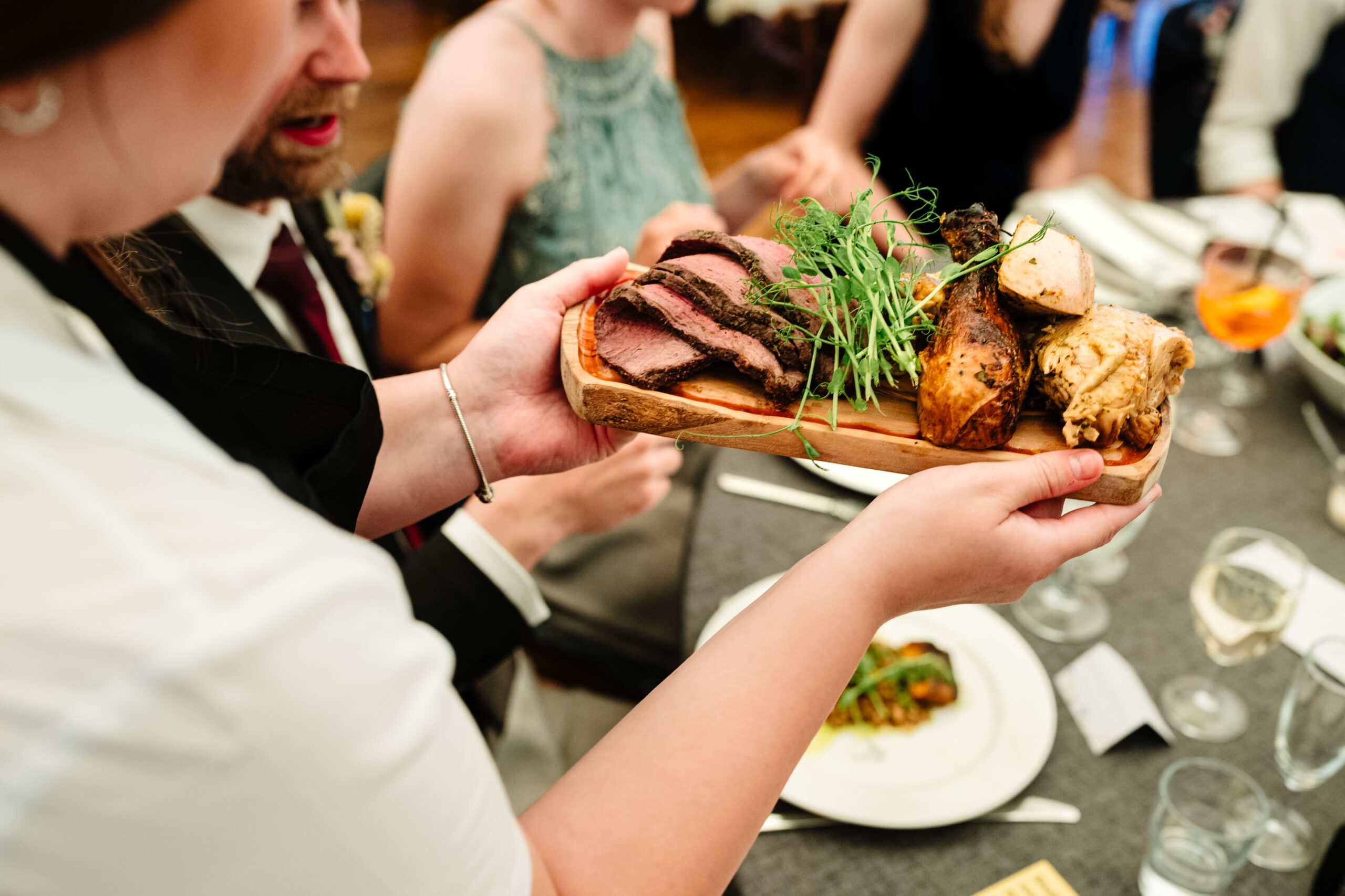 Guests enjoying sharing platters during a relaxed wedding breakfast in Kent.