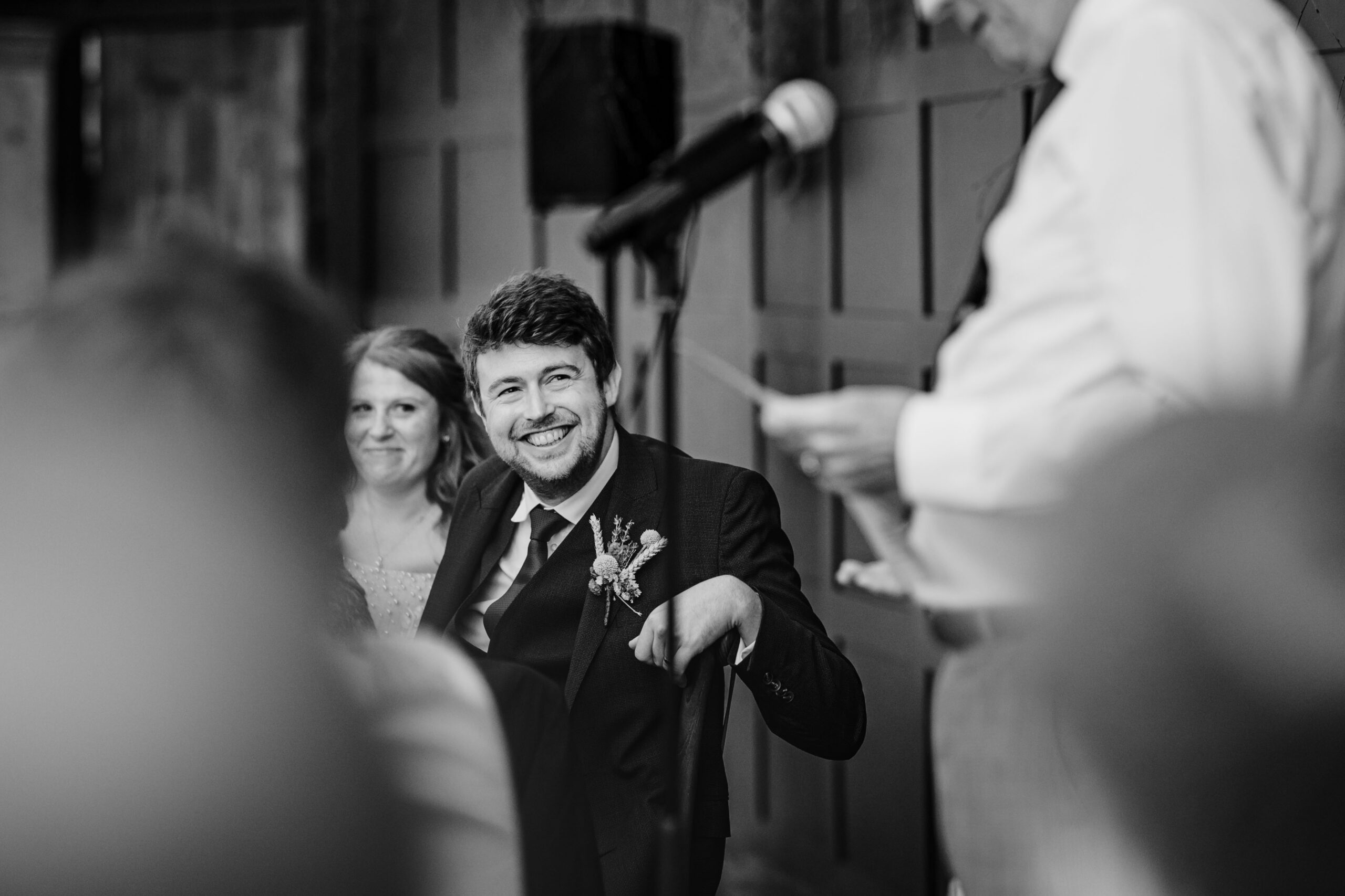 Guest laughing during speeches at a relaxed wedding celebration at The Dreys.