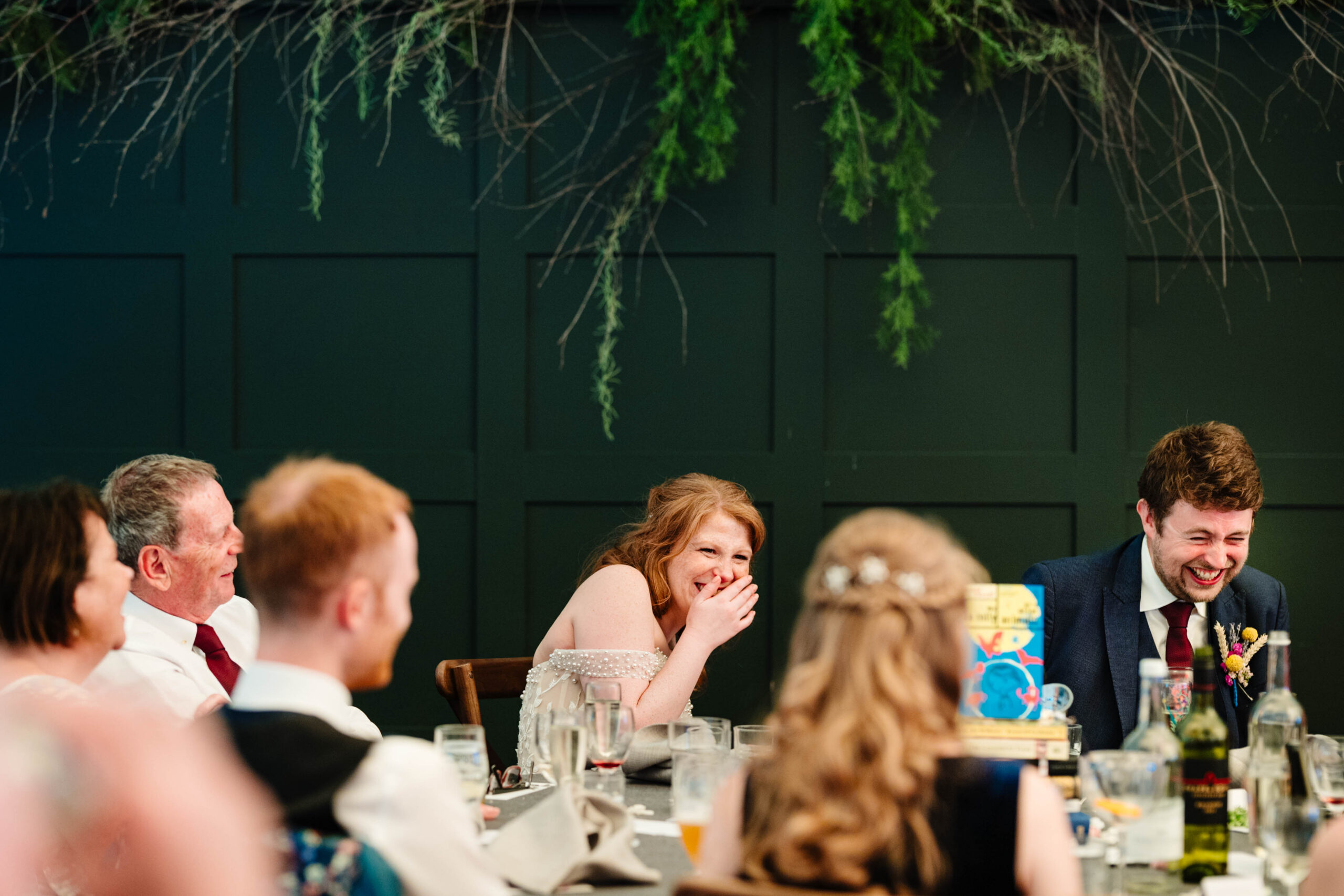 Bride and groom listening to speeches inside the wedding marquee in Kent.