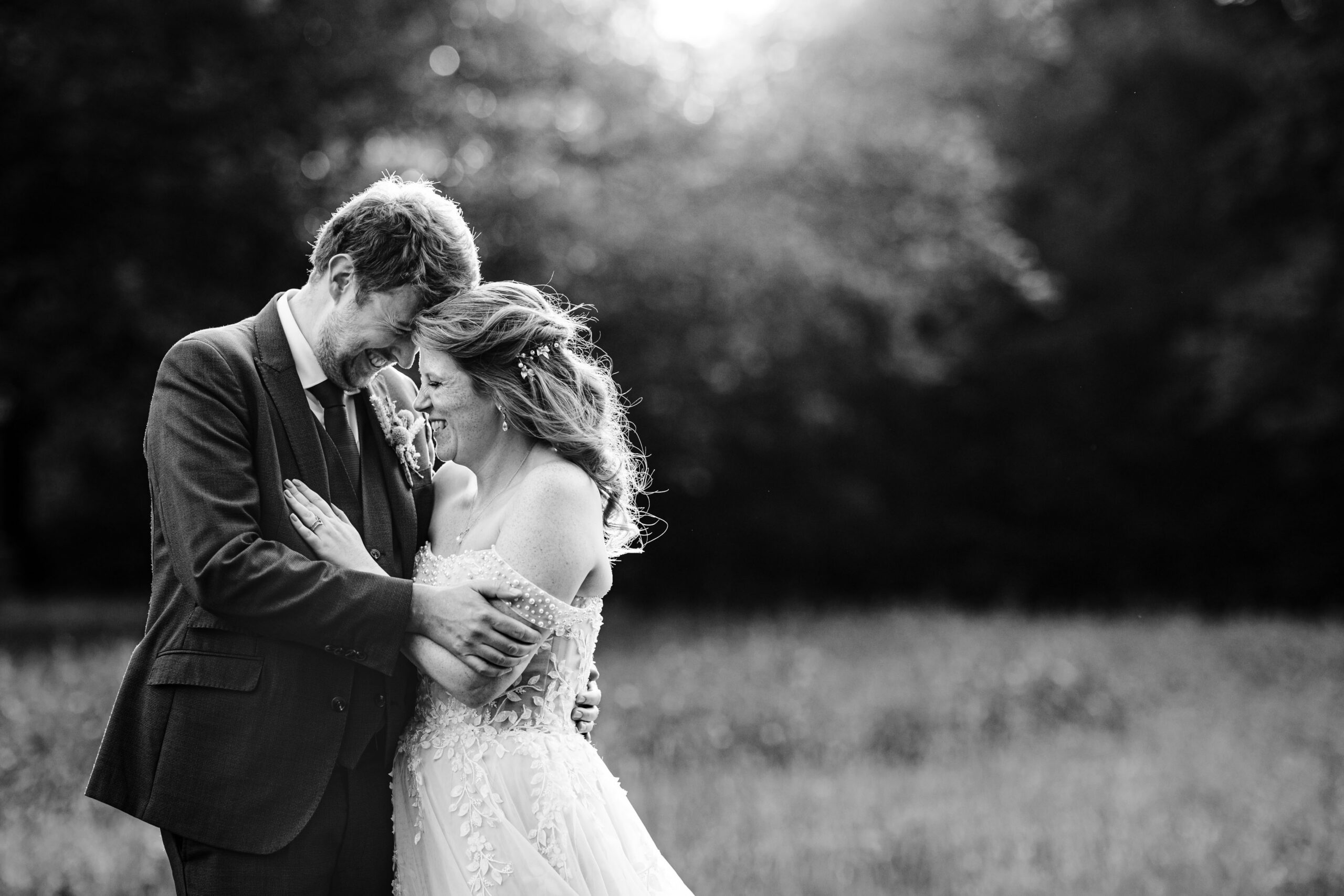 Black and white portrait of bride and groom during golden hour at The Dreys.