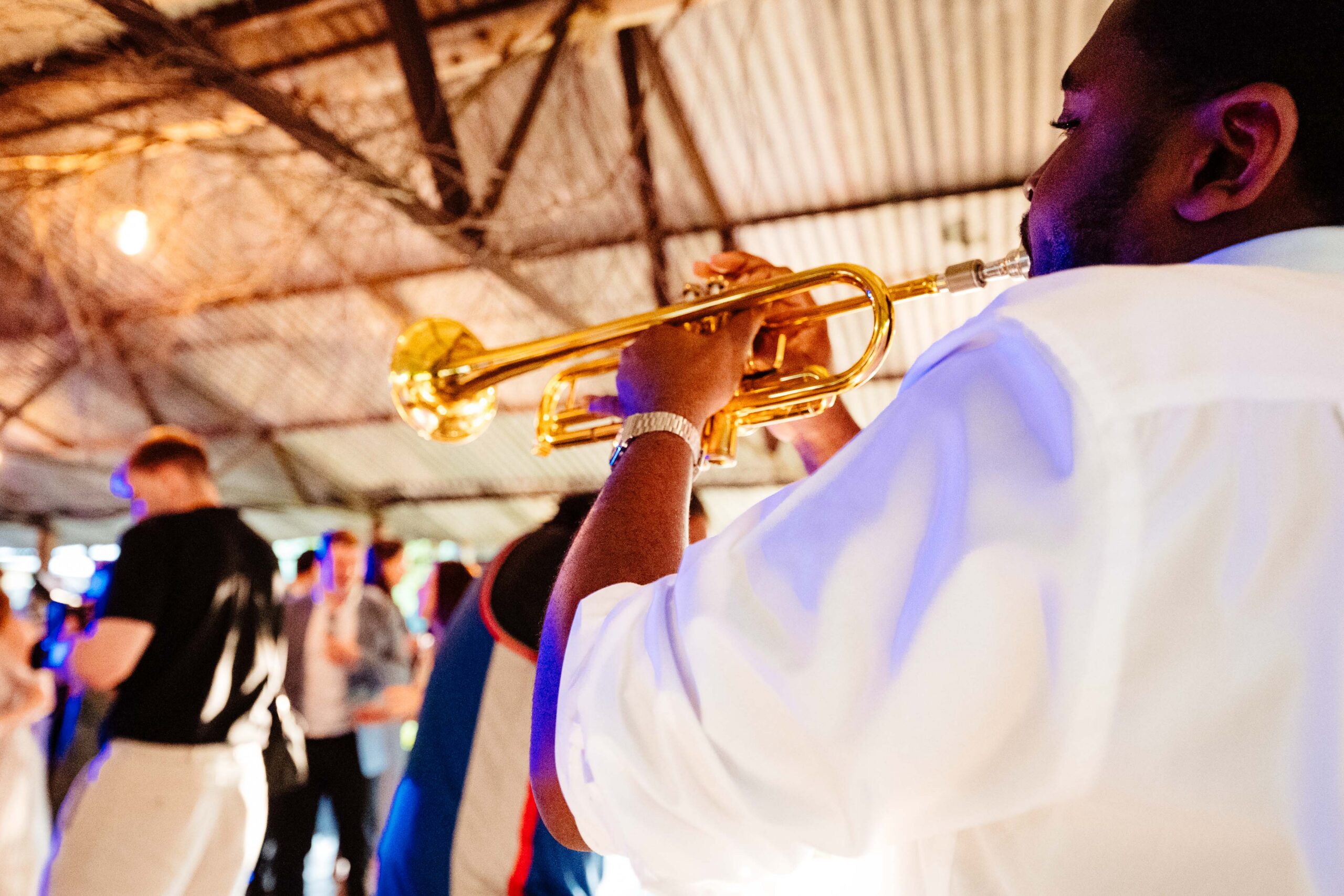 Trumpet player performing during a lively wedding party at The Dreys.